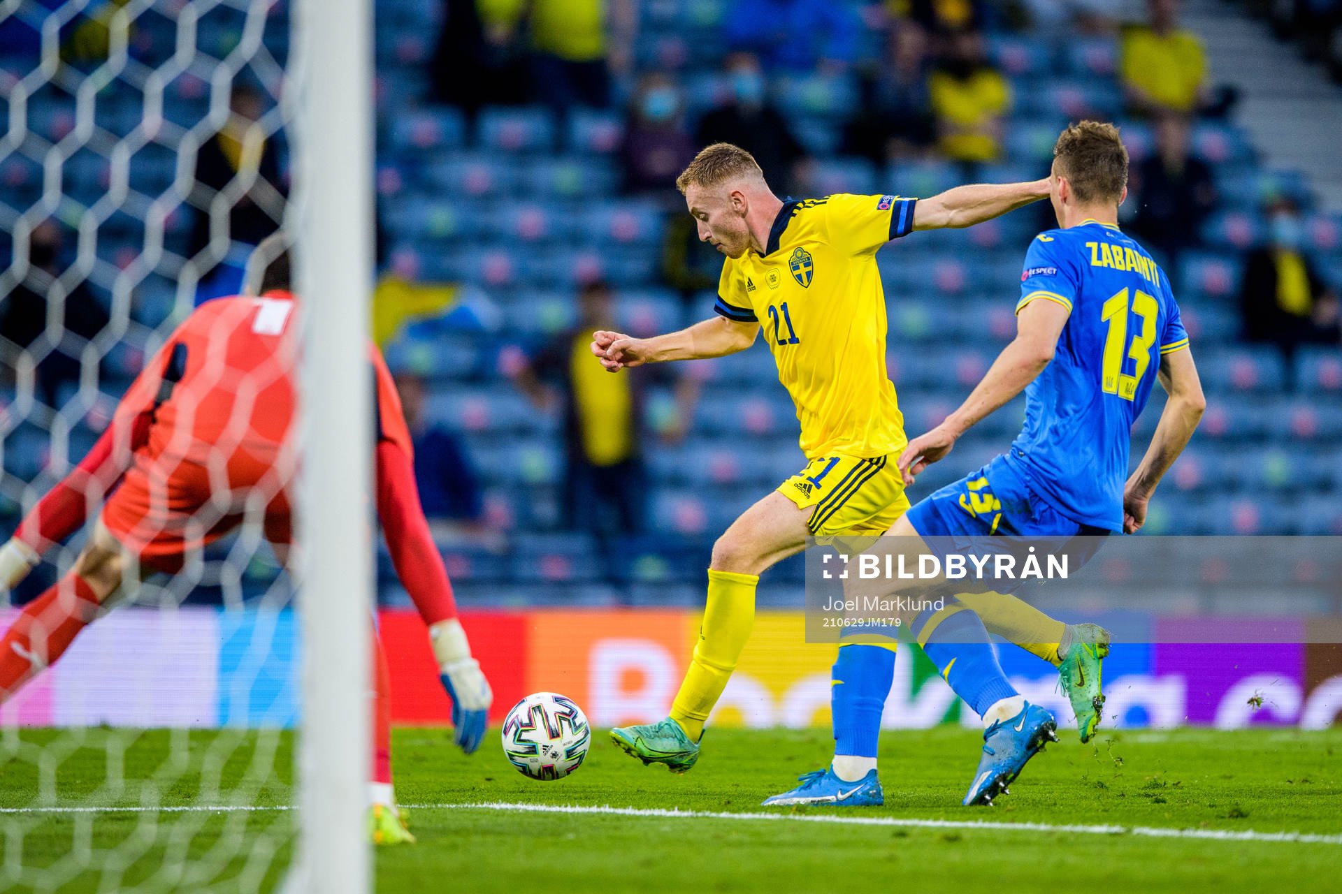 Dejan Kulusevski of Sweden and Illia Zabarnyi of Ukraine