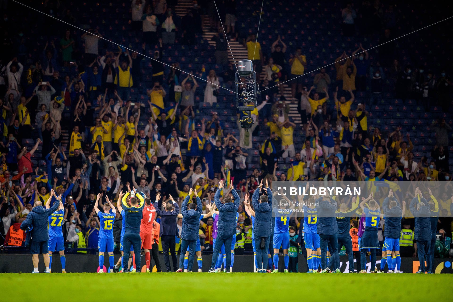 Players of Ukraine celebrate together with their supporters