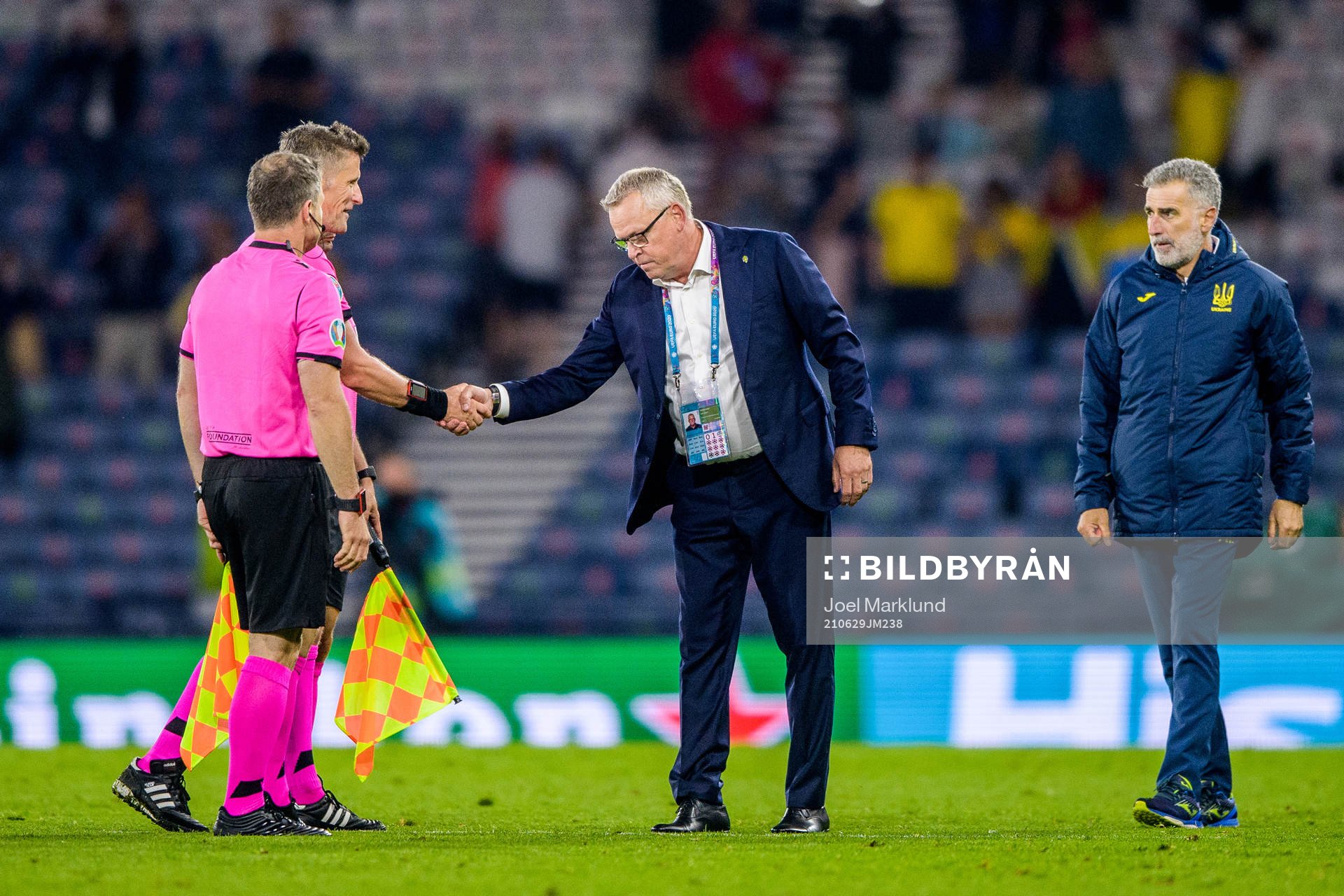 head coach Janne Andersson of Sweden and referee Daniele