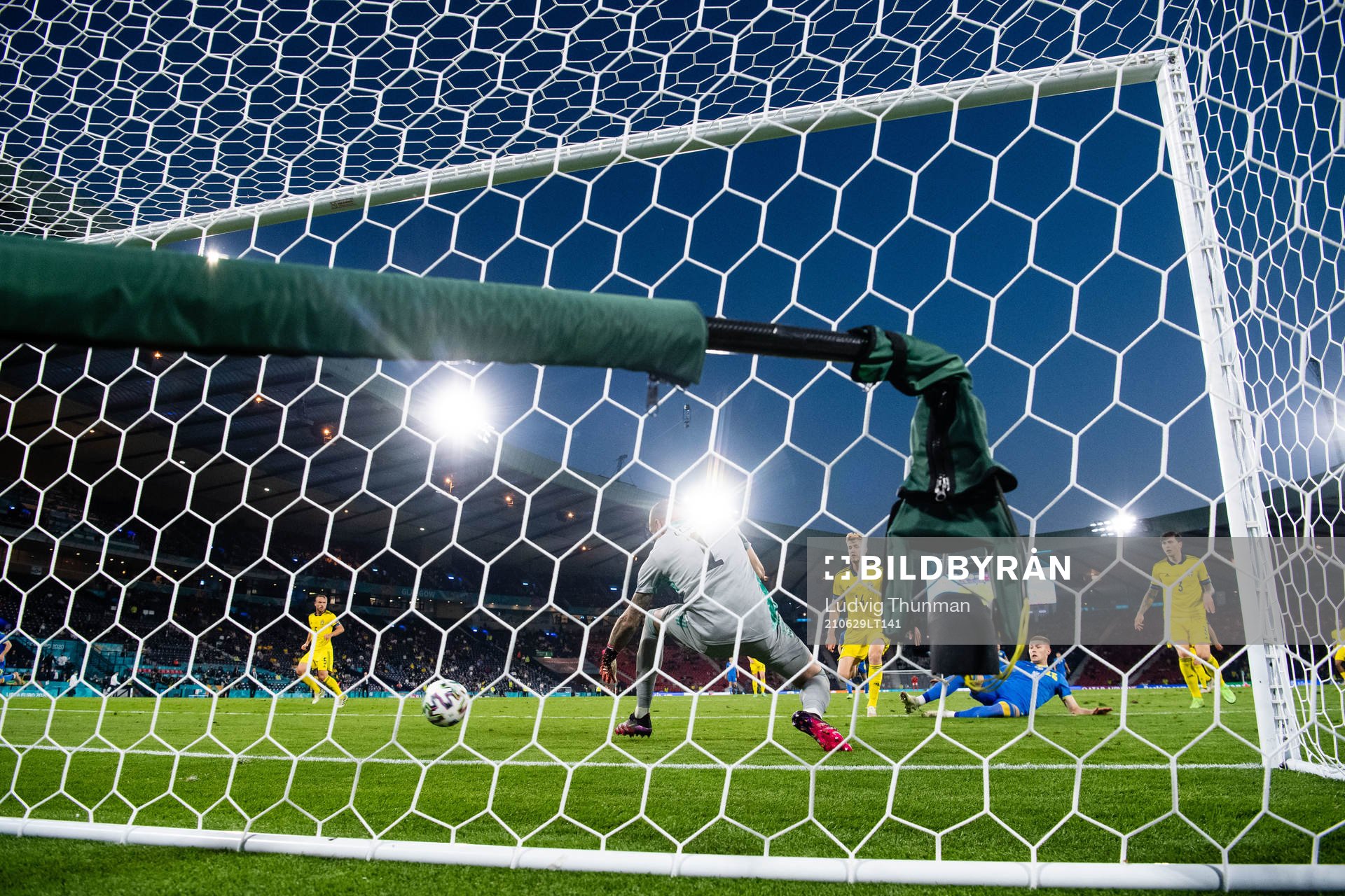 Artem Dovbyk of Ukraine scores 1-2 behind goalkeeper Robin