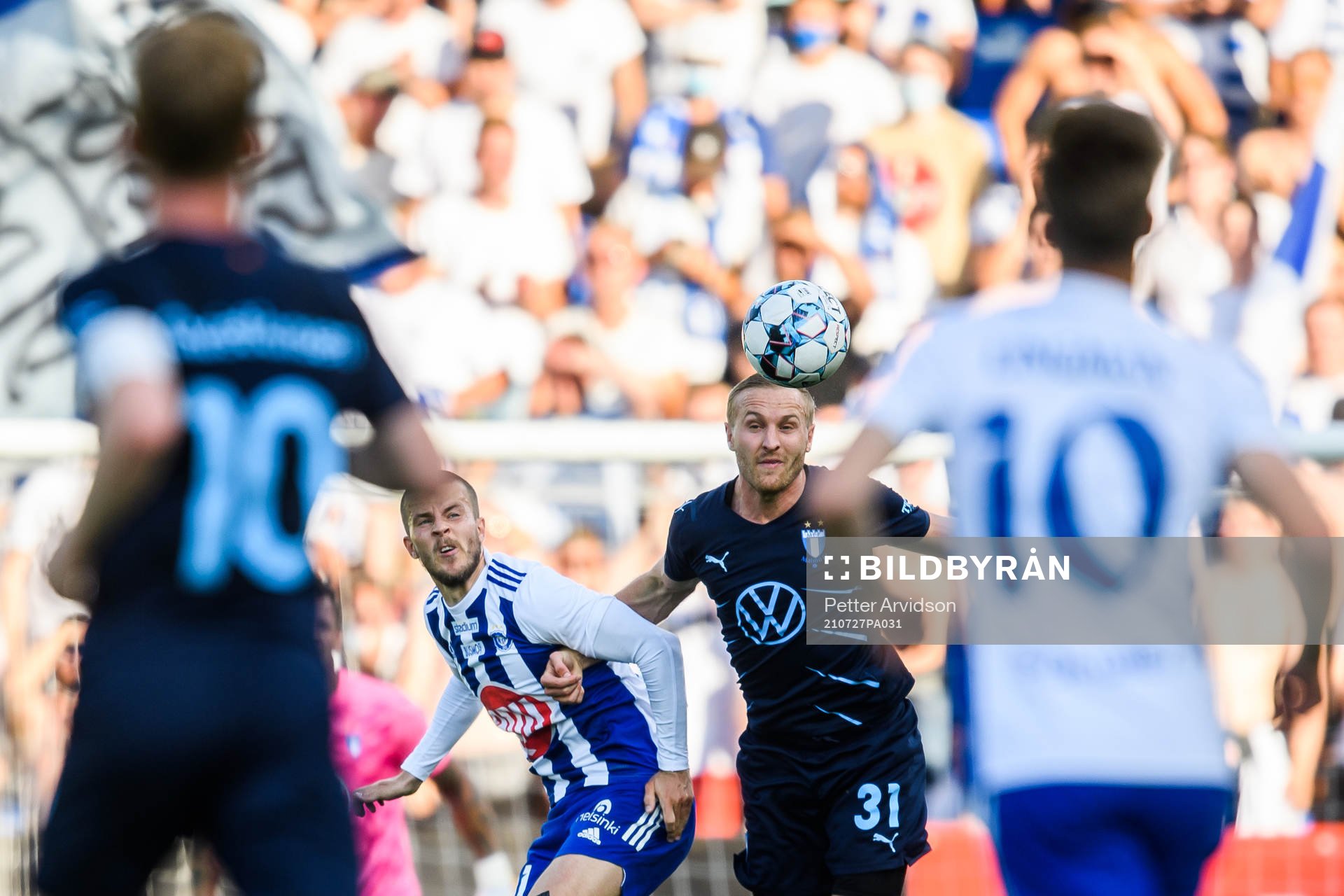Roope Riski of Helsinki and Franz Brorsson of Malmö FF during the UEFA Champions League qualifying match between HJK Helsinki and Malmö FF on July 27, 2021 in Helsinki.