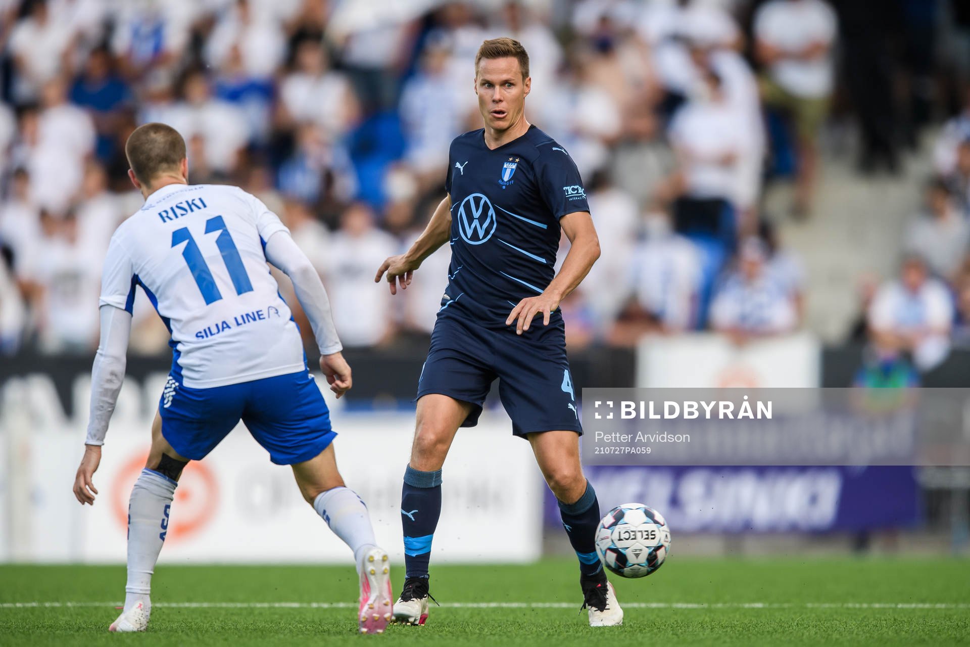Roope Riski of Helsinki and Niklas Moisander of Malmö FF during the UEFA Champions League qualifying match between HJK Helsinki and Malmö FF on July 27, 2021 in Helsinki.