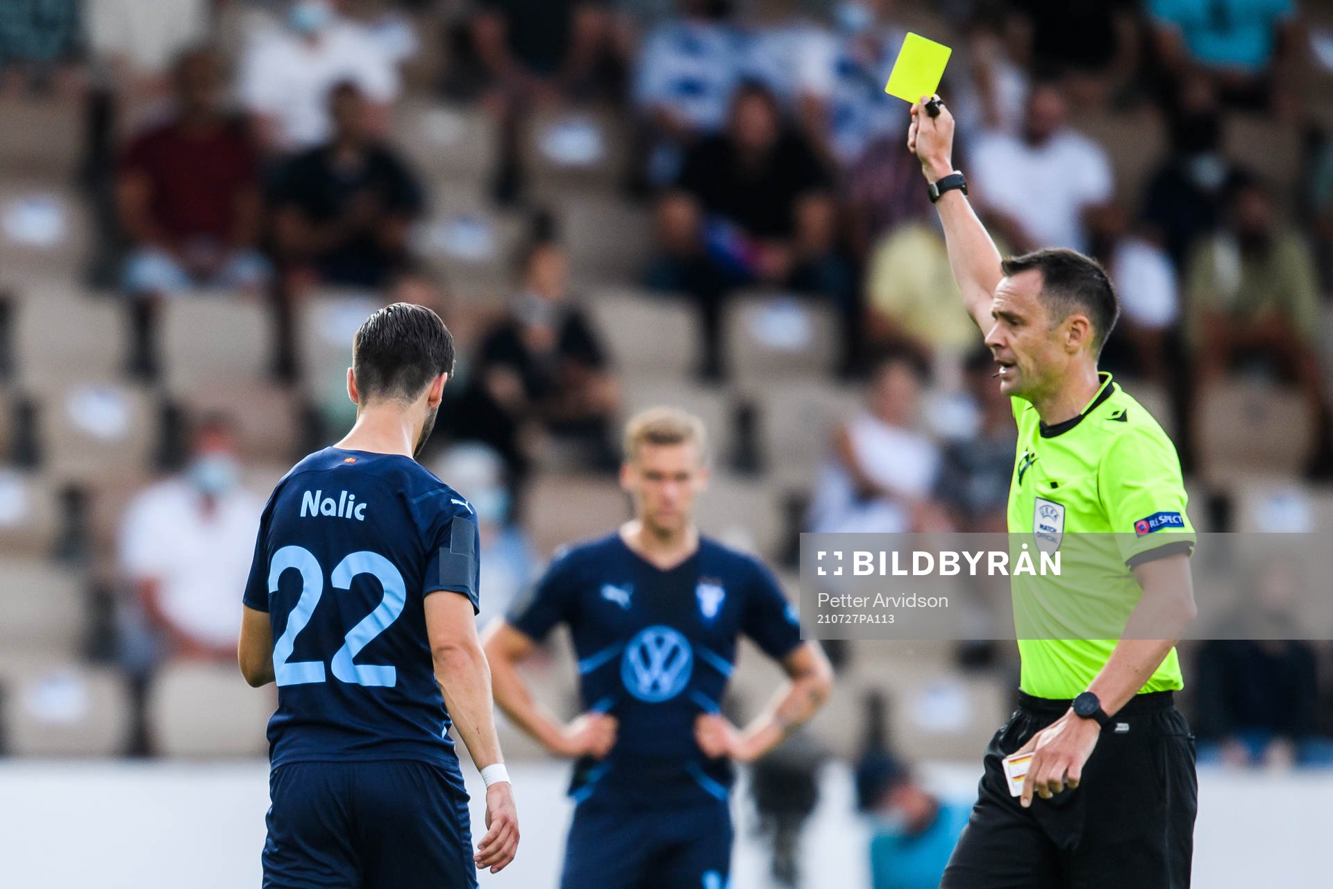 Adi Nalic of Malmö FF is shown a yellow card by Referee