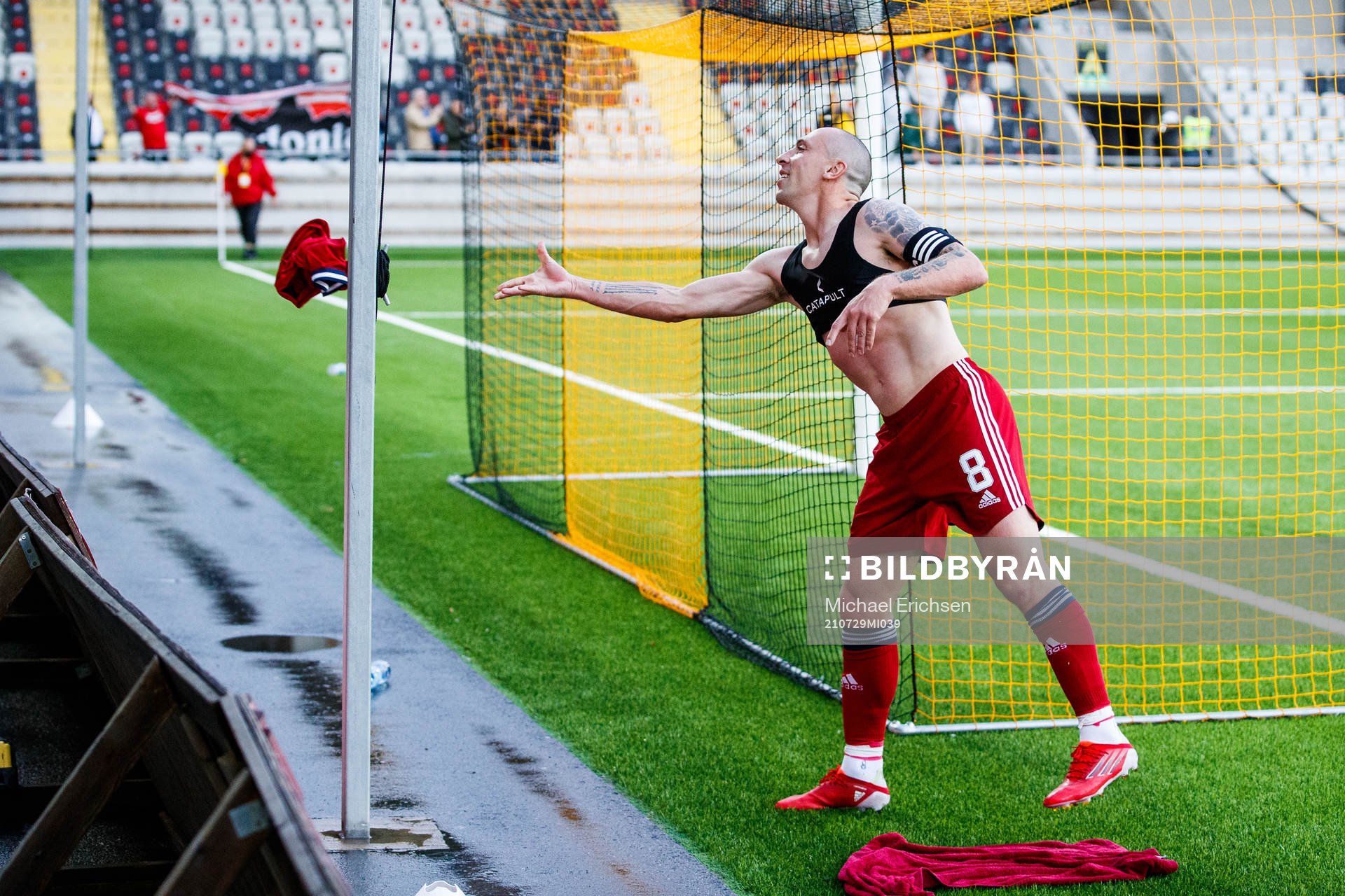 Scott Brown of Aberdeen throws his jersey to a supporter
