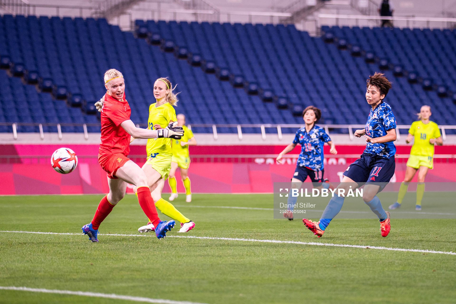 Mina Tanaka of Japan scores the 1-0 goal behind goalkeeper