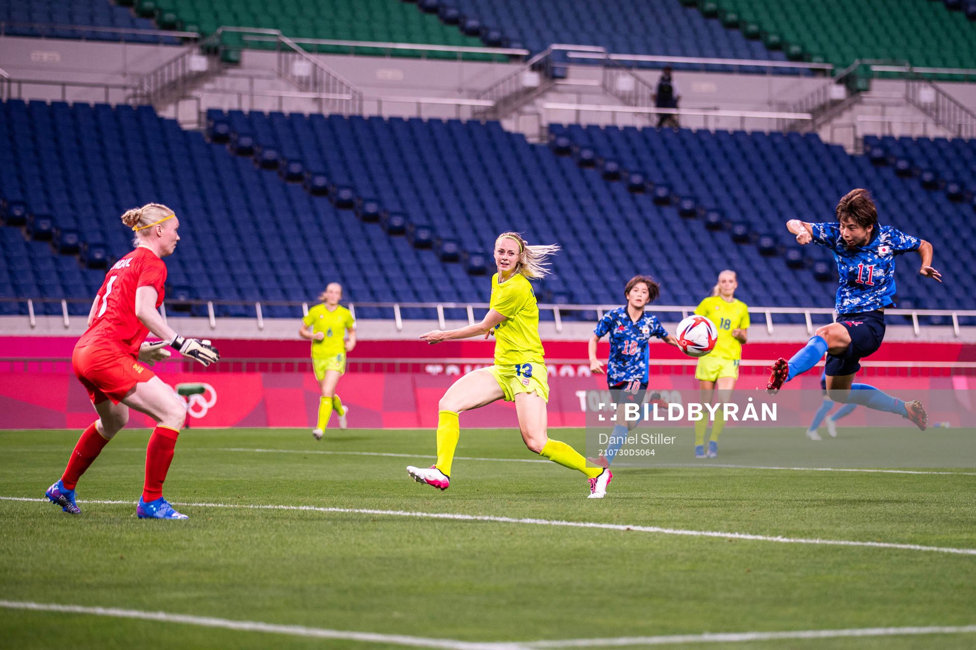 Mina Tanaka of Japan scores the 1-0 goal behind goalkeeper