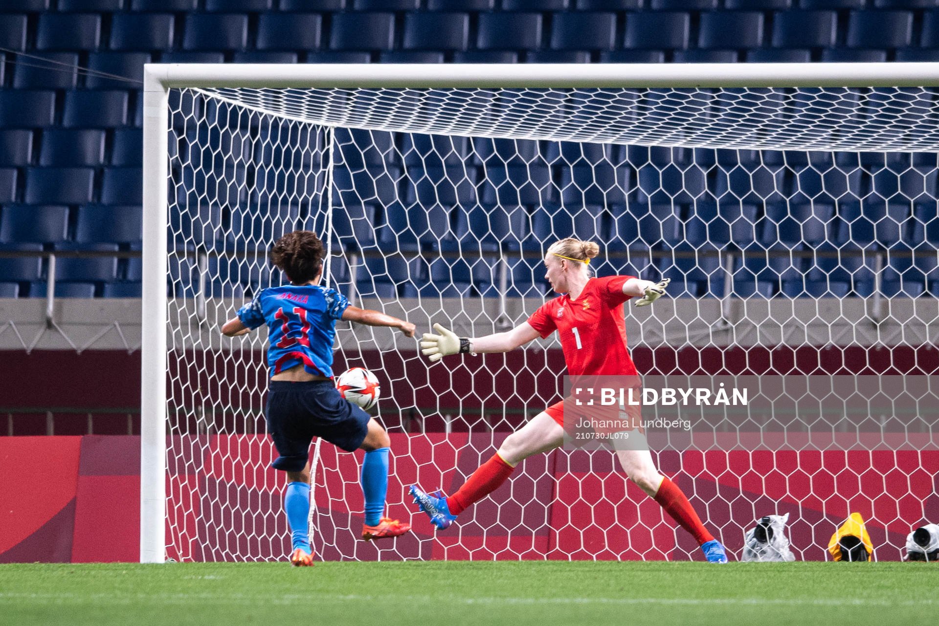 Mina Tanaka of Japan scores the 1-1 goal behind goalkeeper