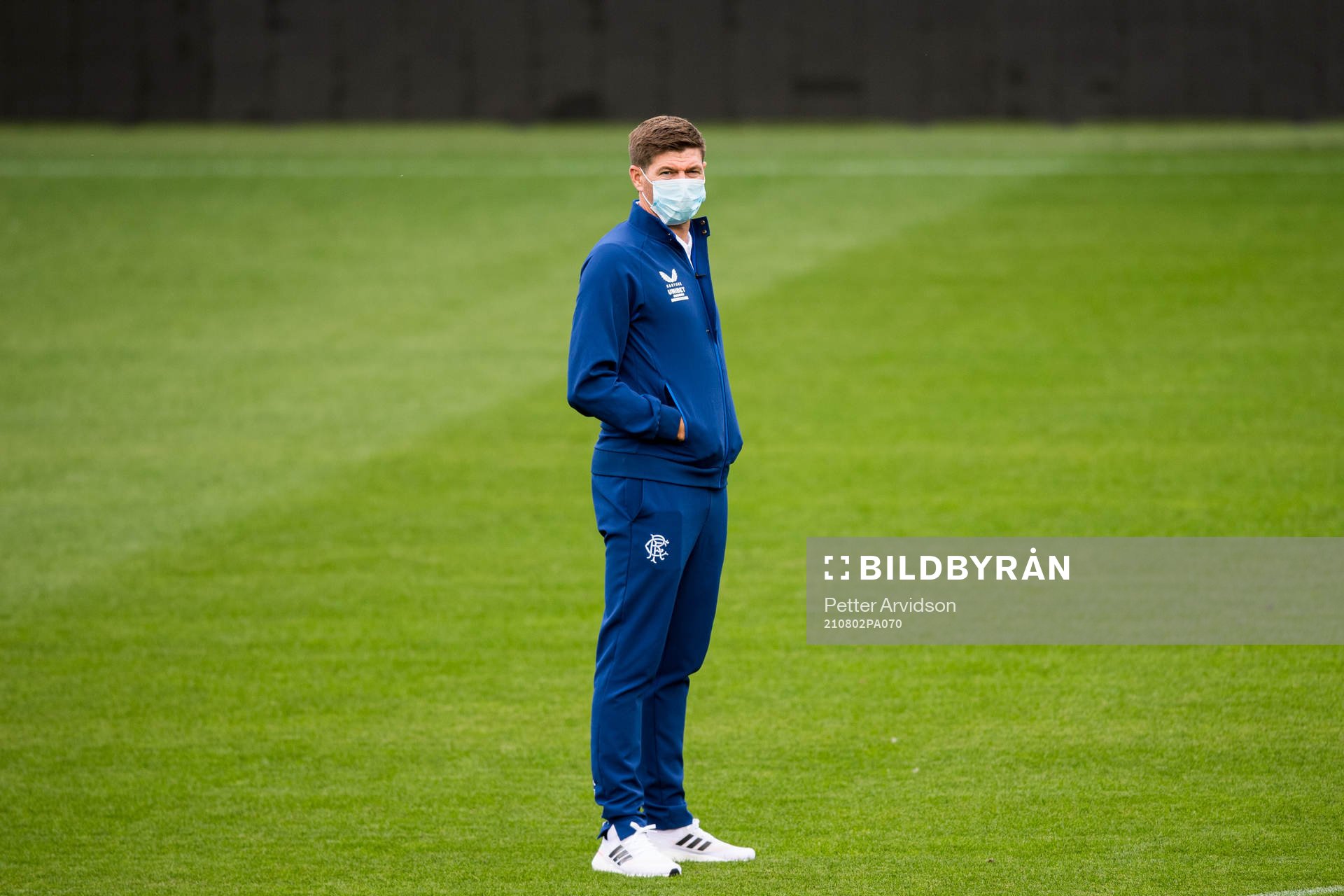 Steven Gerrard, head coach of Rangers inspect the pitch