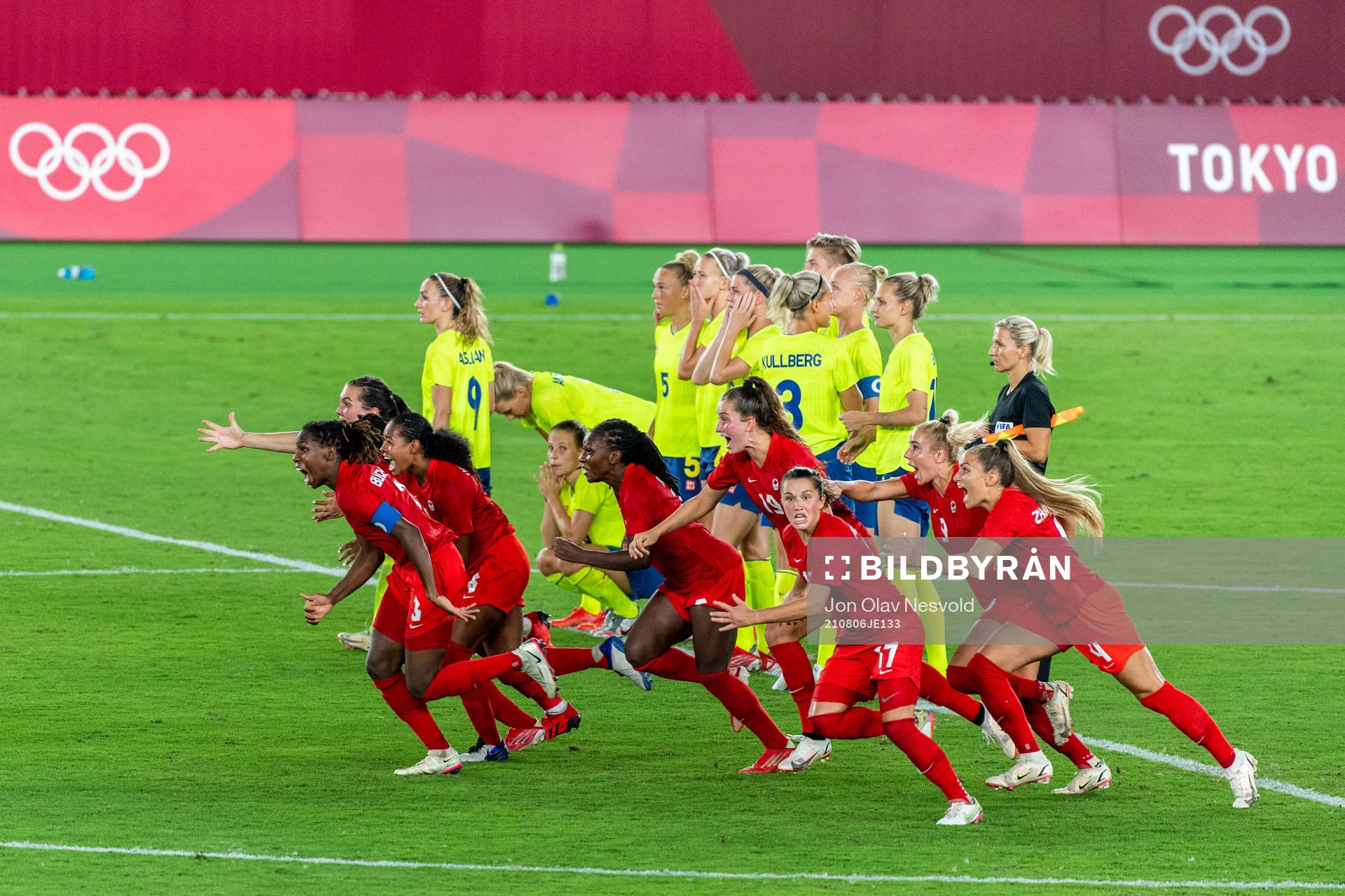 Players of Canada celebrate winning the women’s football