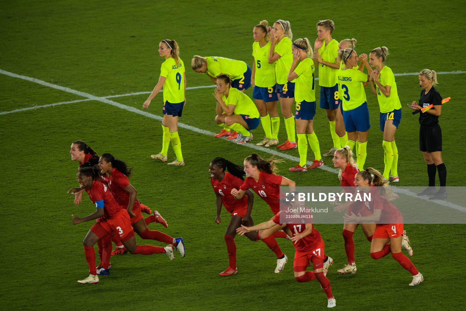 Players of Sweden look dejected while the Canadian players