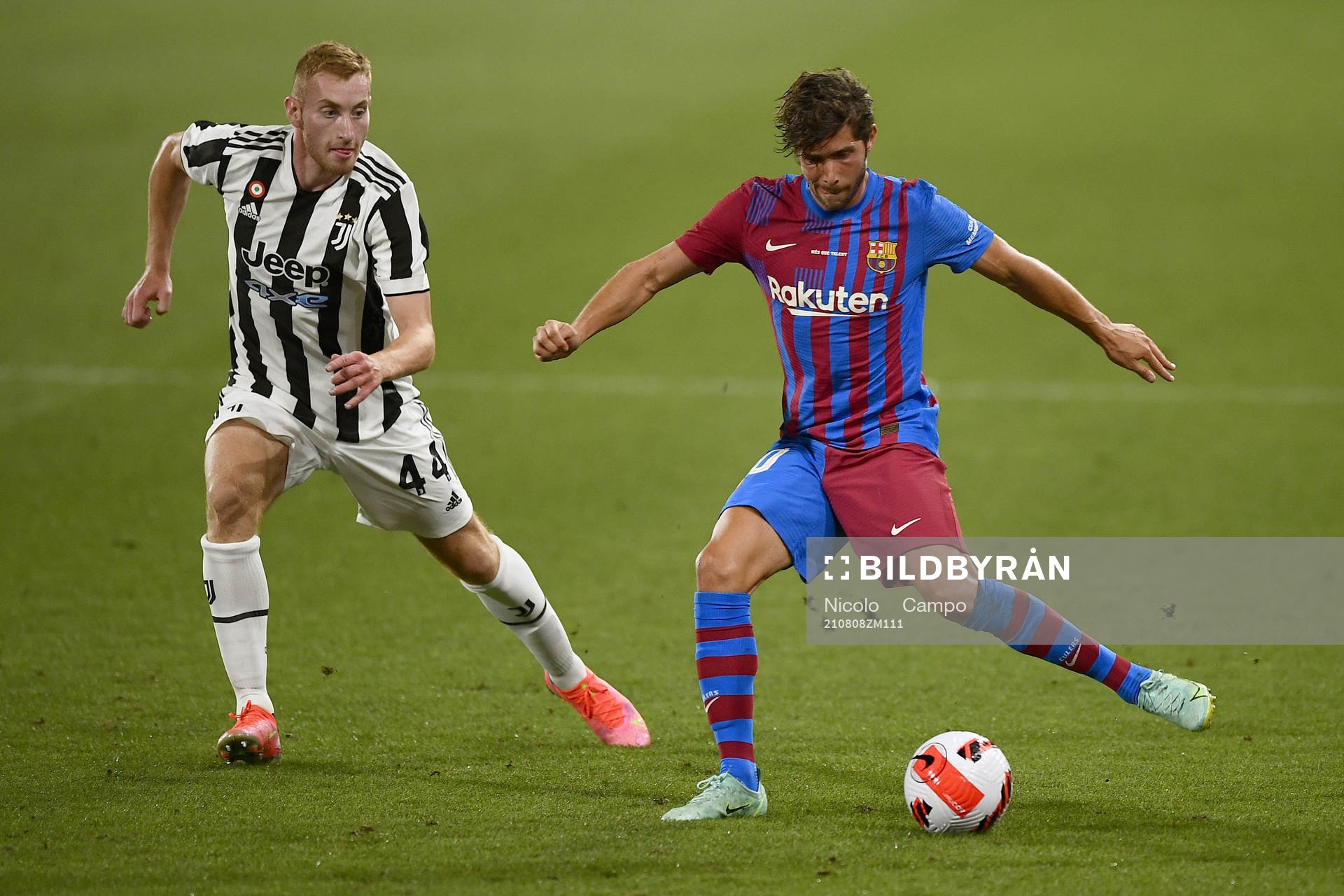 Dejan Kulusevski of Juventus and Sergi Roberto of Barcelona during a friendly match between Juventus and Barcelona on August 2, 2021 in Barcelona.