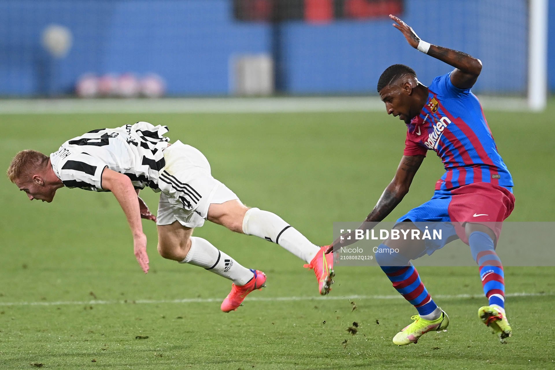 Emerson Royal of Barcelona and Dejan Kulusevski of Juventus during a friendly match between Juventus and Barcelona on August 2, 2021 in Barcelona.