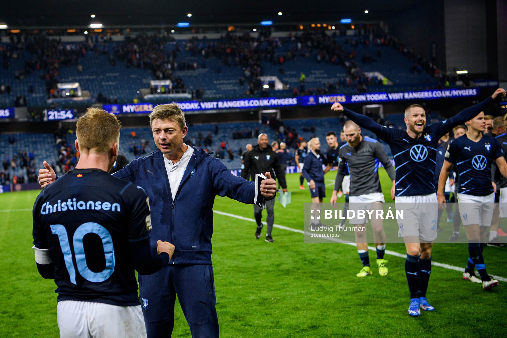 Anders Christiansen, Jon Dahl Tomasson, head coach and Lasse Nielsen of Malmö FF celebrate after the UEFA Champions League qualifying match between Rangers and Malmö FF on August 10, 2021 in Glasgow.
