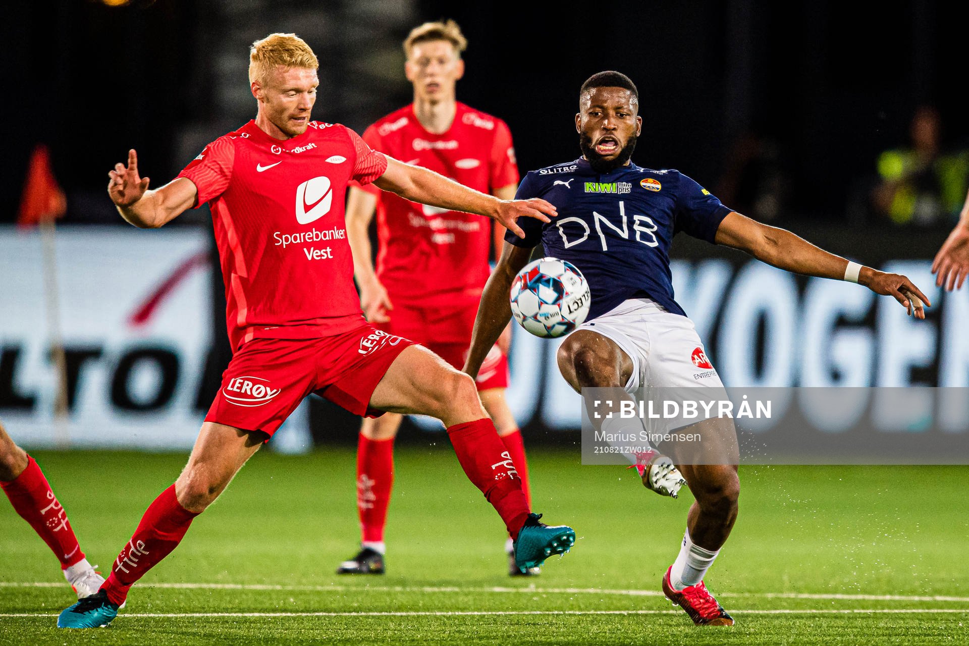 Sivert Heltne Nilsen of Brann and Imoh Fred Friday of Strømsgodset during the Eliteserien match between Strømsgodset and Brann on August 21, 2021 in Drammen.
