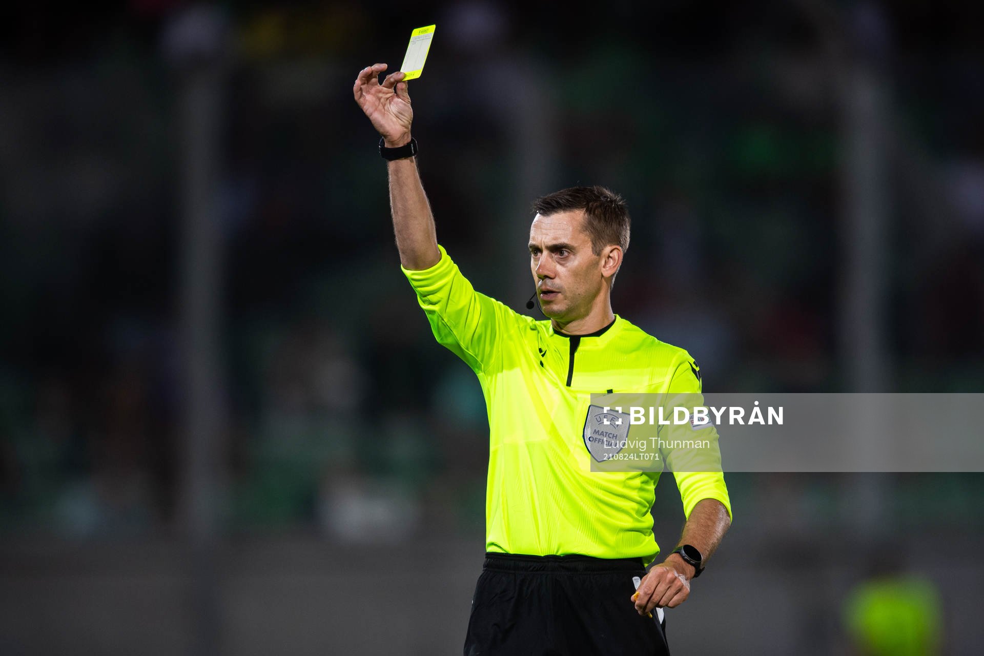 Referee Clement Turpin shows a yellow card