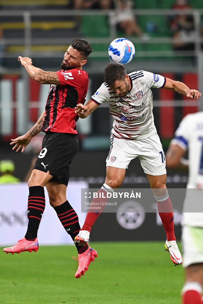 Olivier Giroud of Milan and Kevin Strootman of Cagliari