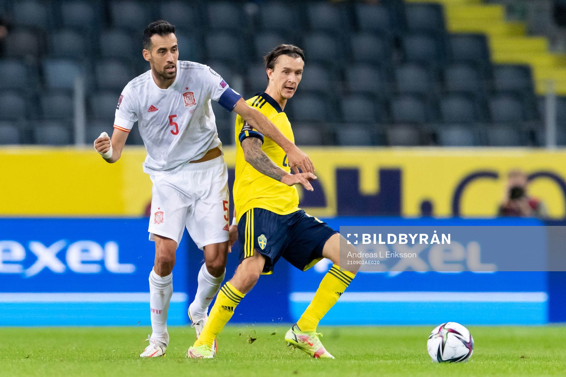 Sergio Busquets of Spain and Kristoffer Olsson of Sweden