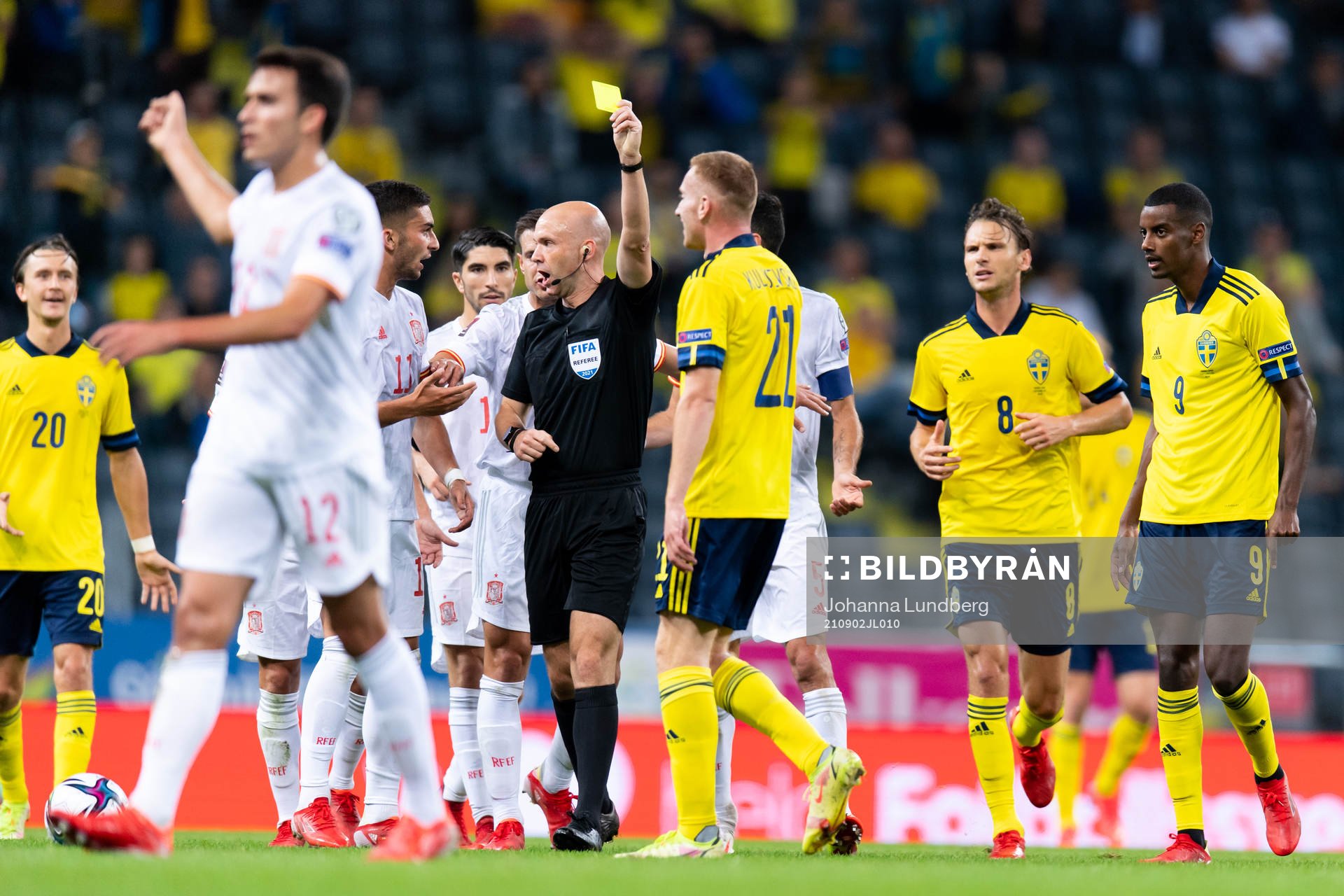 Dejan Kulusevski of Sweden is shown a yellow  card