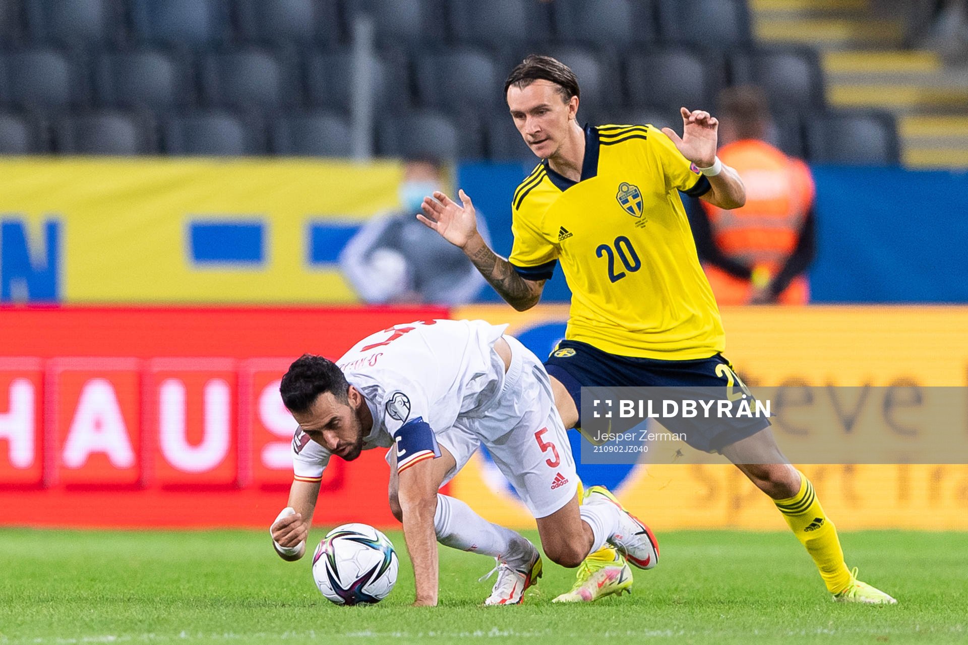 Sergio Busquets of Spain and Kristoffer Olsson of Sweden