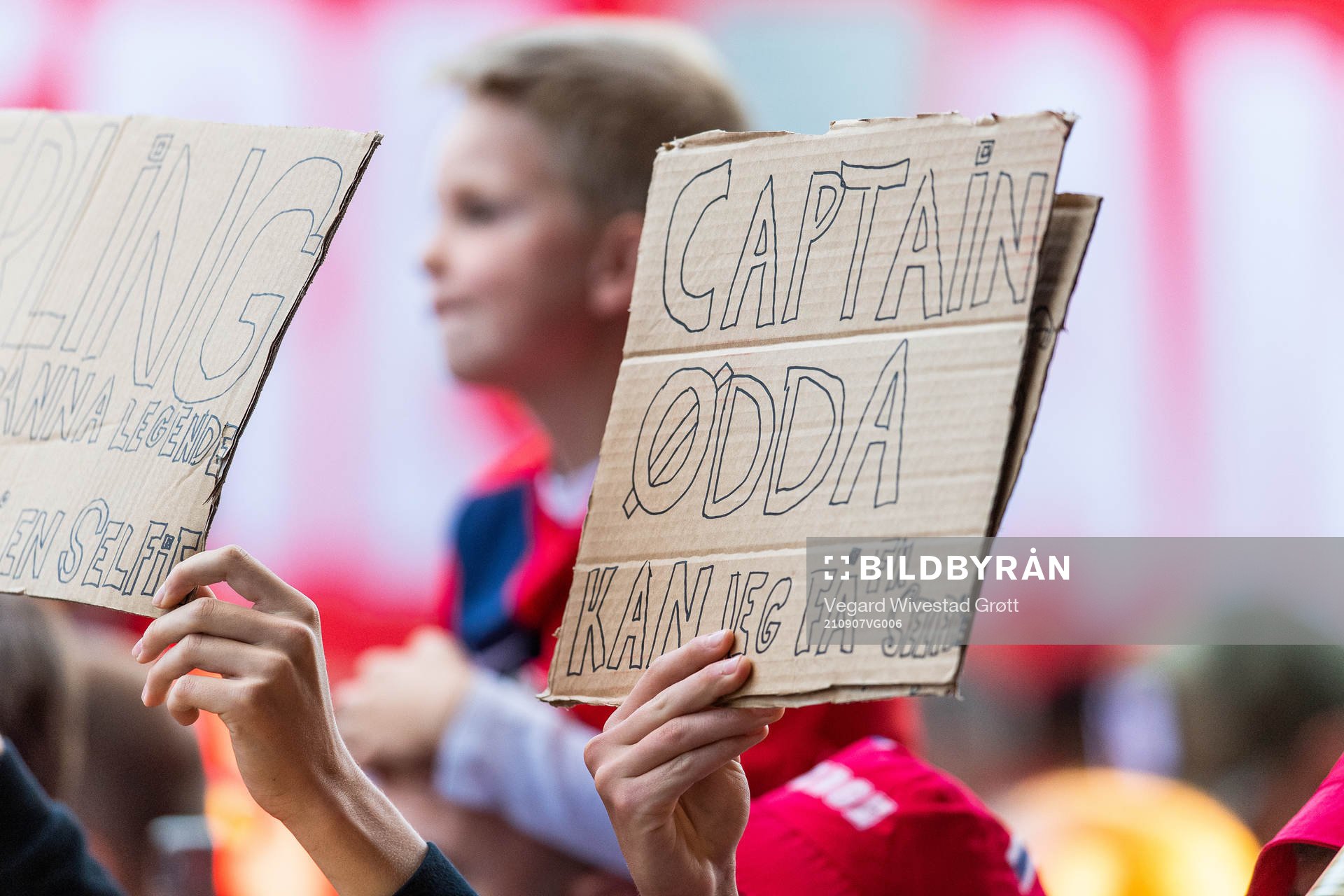 A fan holds up a sign directed to Martin Ødegaard of Norway