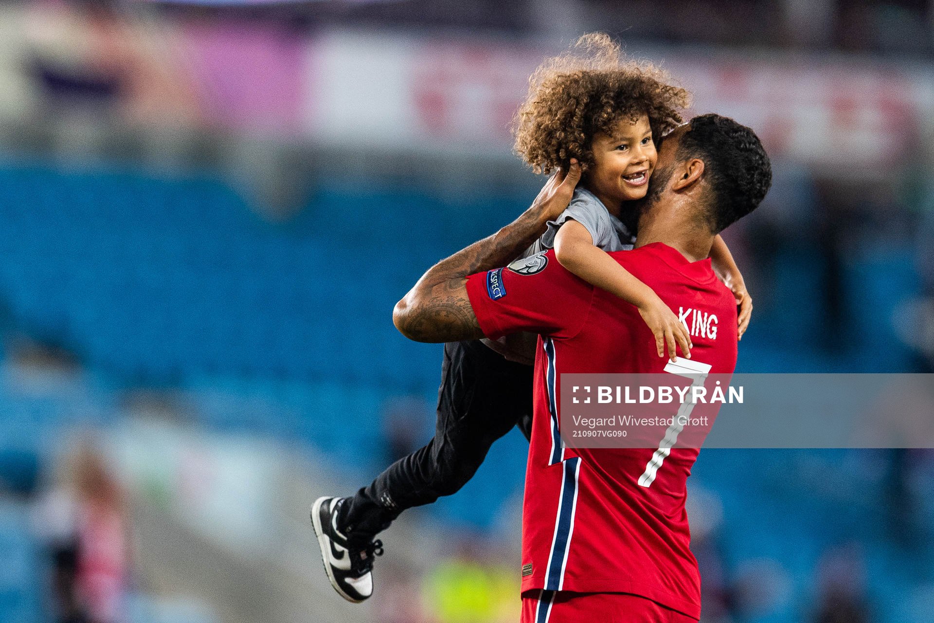 Joshua King of Norway embraces his son