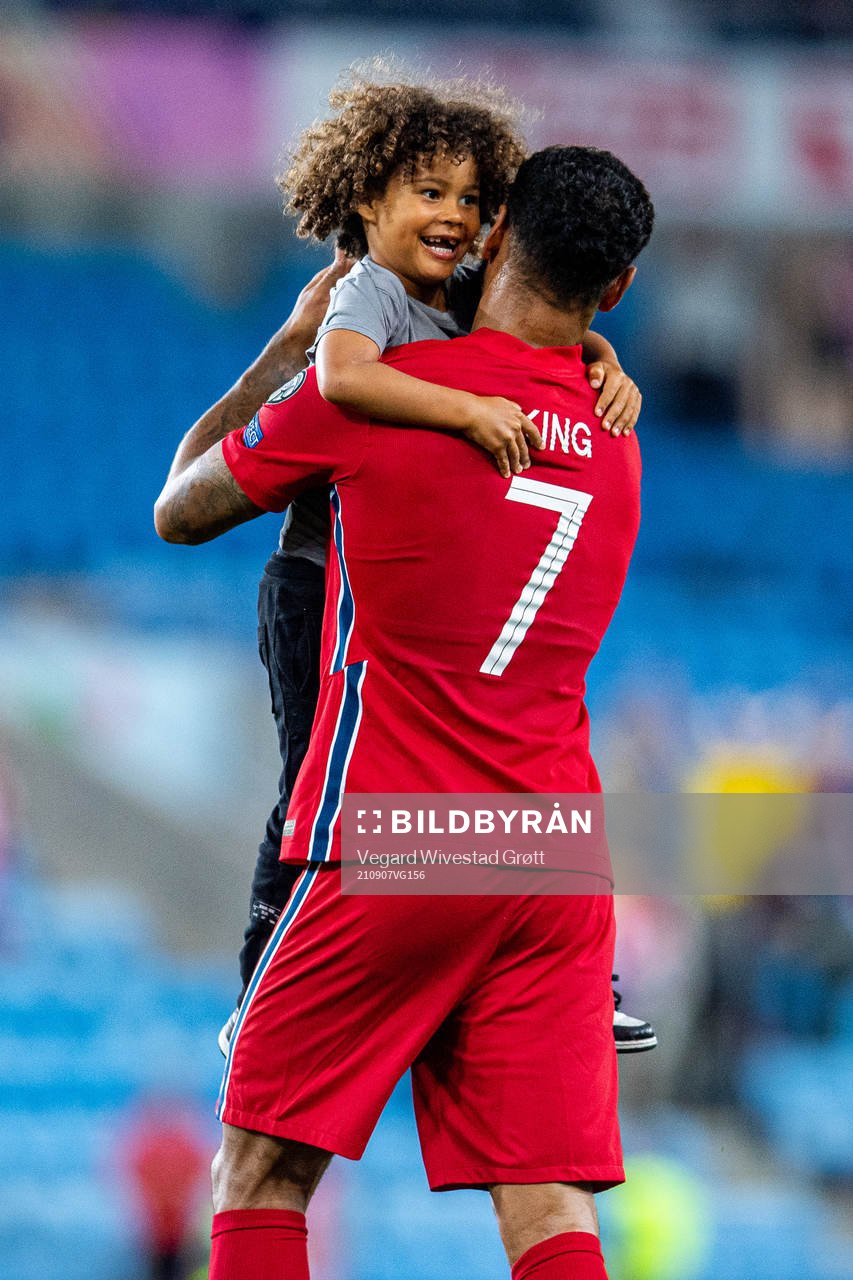 Joshua King of Norway embraces his son
