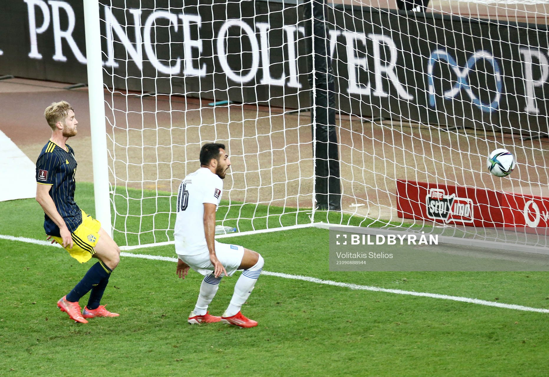 Filip Helander of Sweden sees Vangelis Pavlidis of Greece
