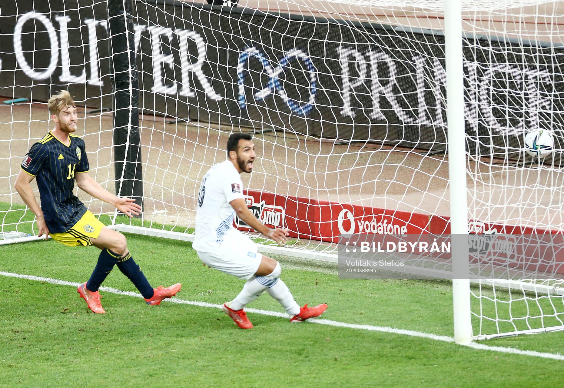 Filip Helander of Sweden sees Vangelis Pavlidis of Greece
