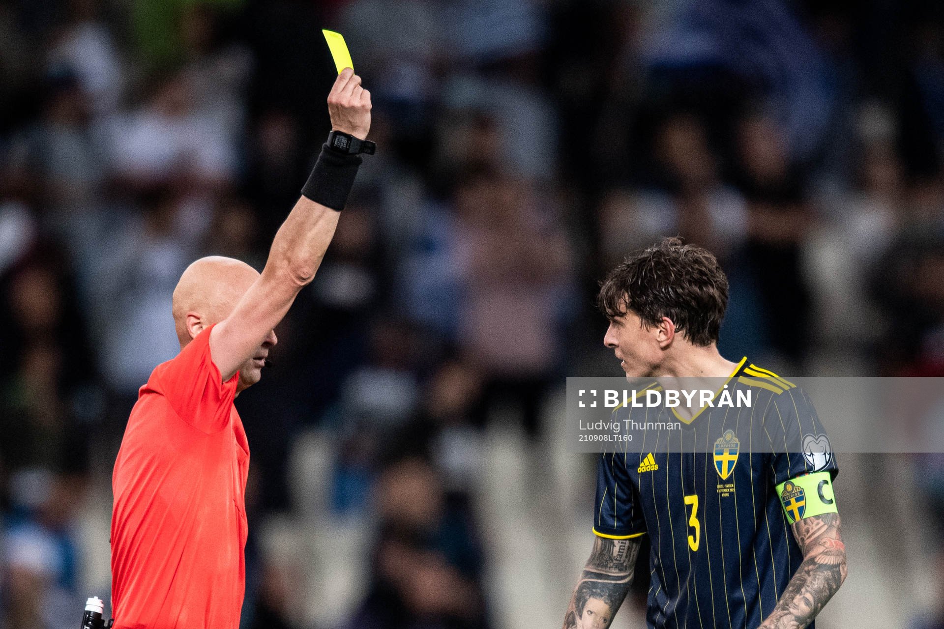 Victor Nilsson Lindelöf of Sweden receives a yellow card
