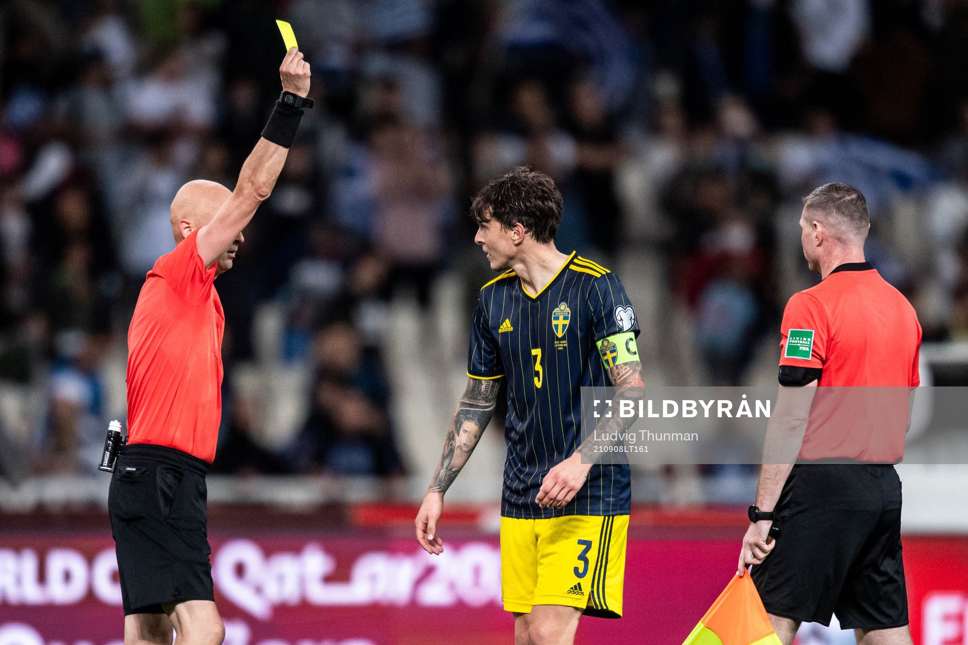 Victor Nilsson Lindelöf of Sweden receives a yellow card