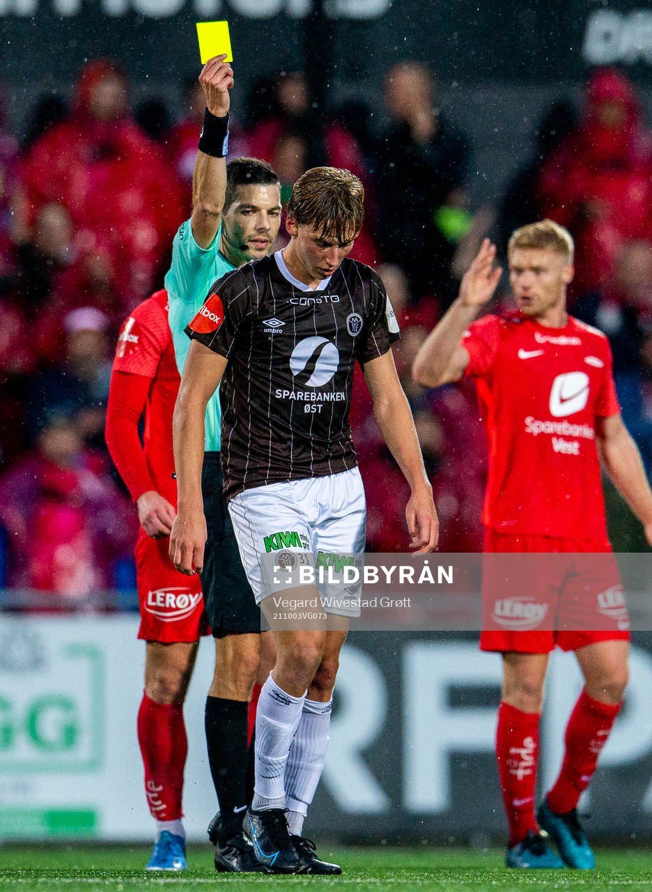 Albin Sporrong of Mjøndalen gets a yellow card from