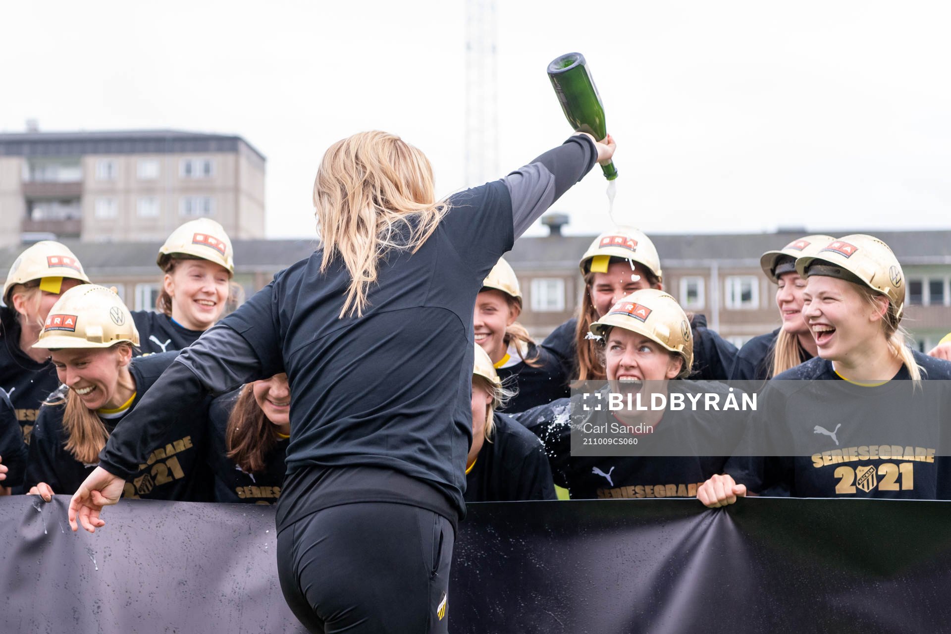 Häckens tränare Erika Faith häller champagne på spelarna