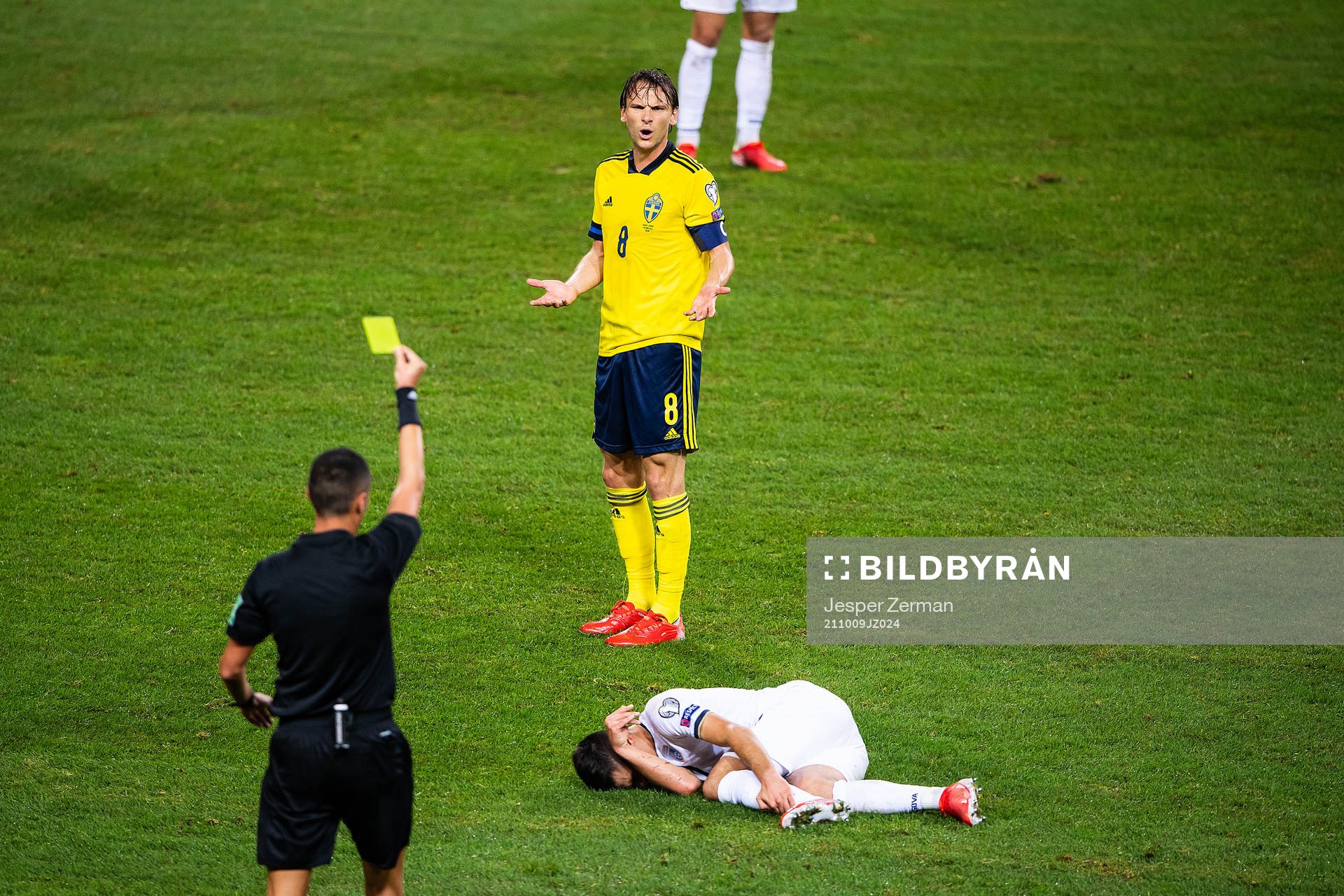 Albin Ekdal of Sweden is shown a yellow card by referee