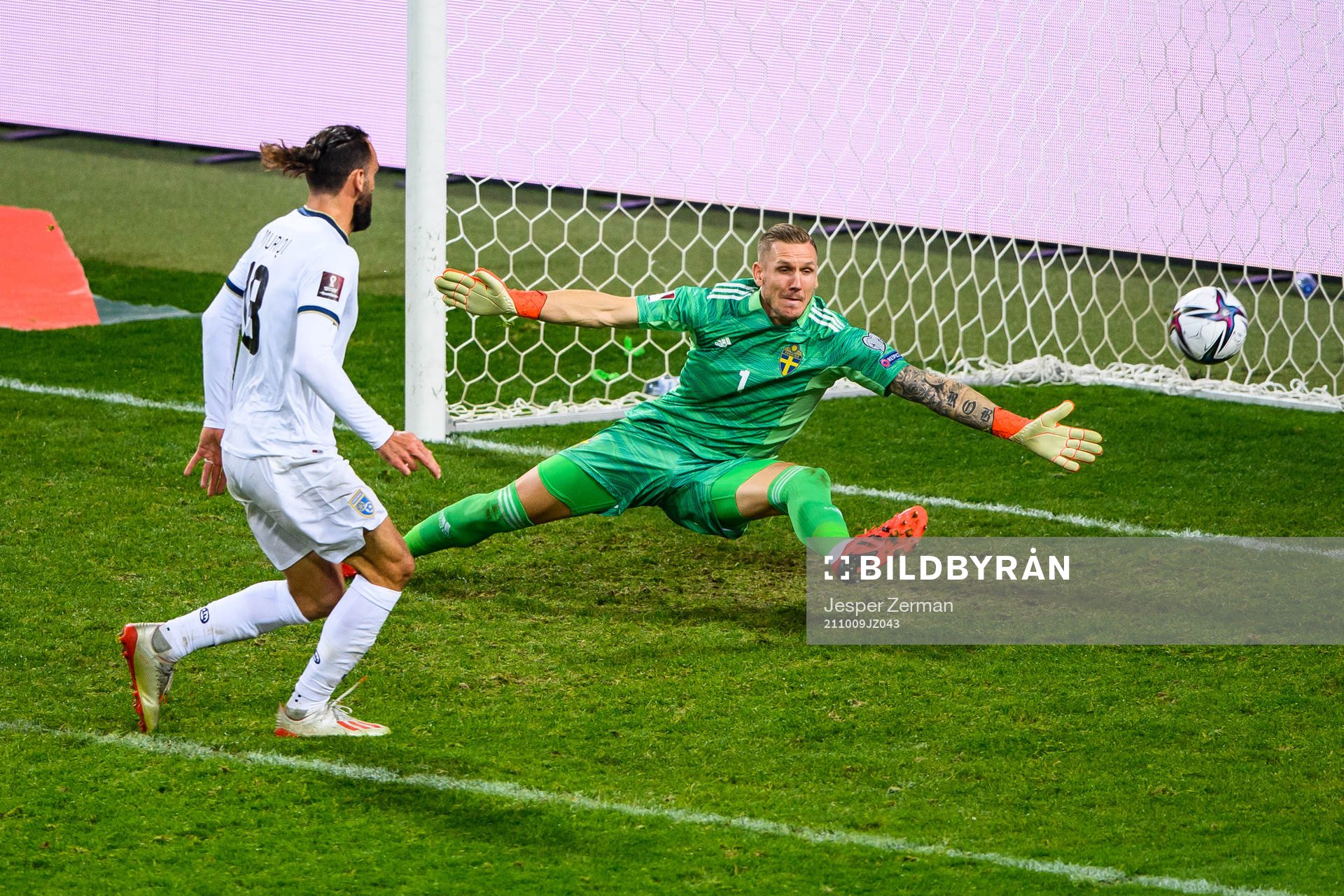 Vedat Muriqi of Kosovo and goalkeeper Robin Olsen of Sweden