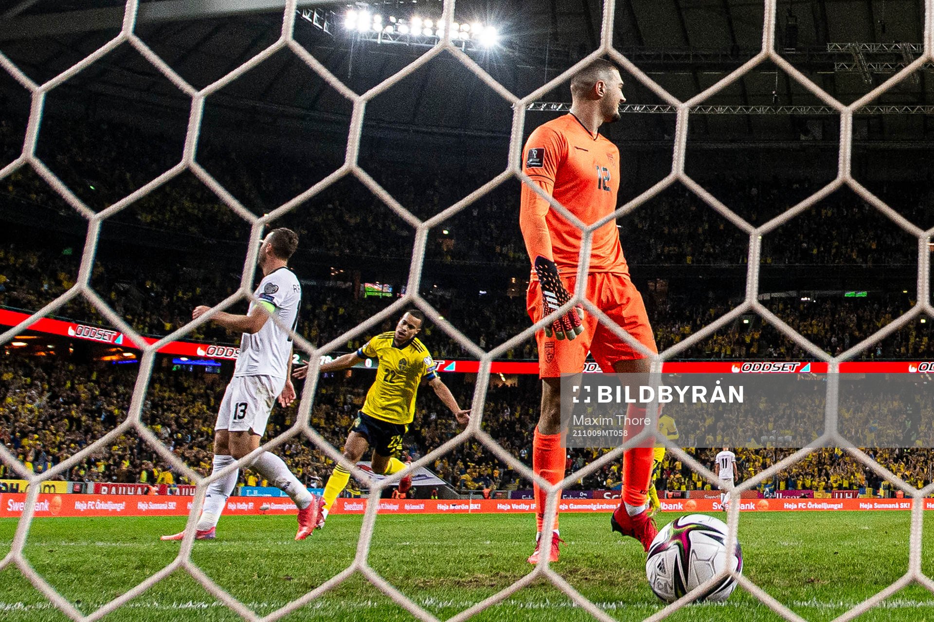 Robin Quaison of Sweden celebrates after scoring the 3-0 goal behind goalkeeper Arijanet Muric of Kosovo during the FIFA World Cup Qualifier football match between Sweden and Kosovo on October 9, 2021 in Stockholm.