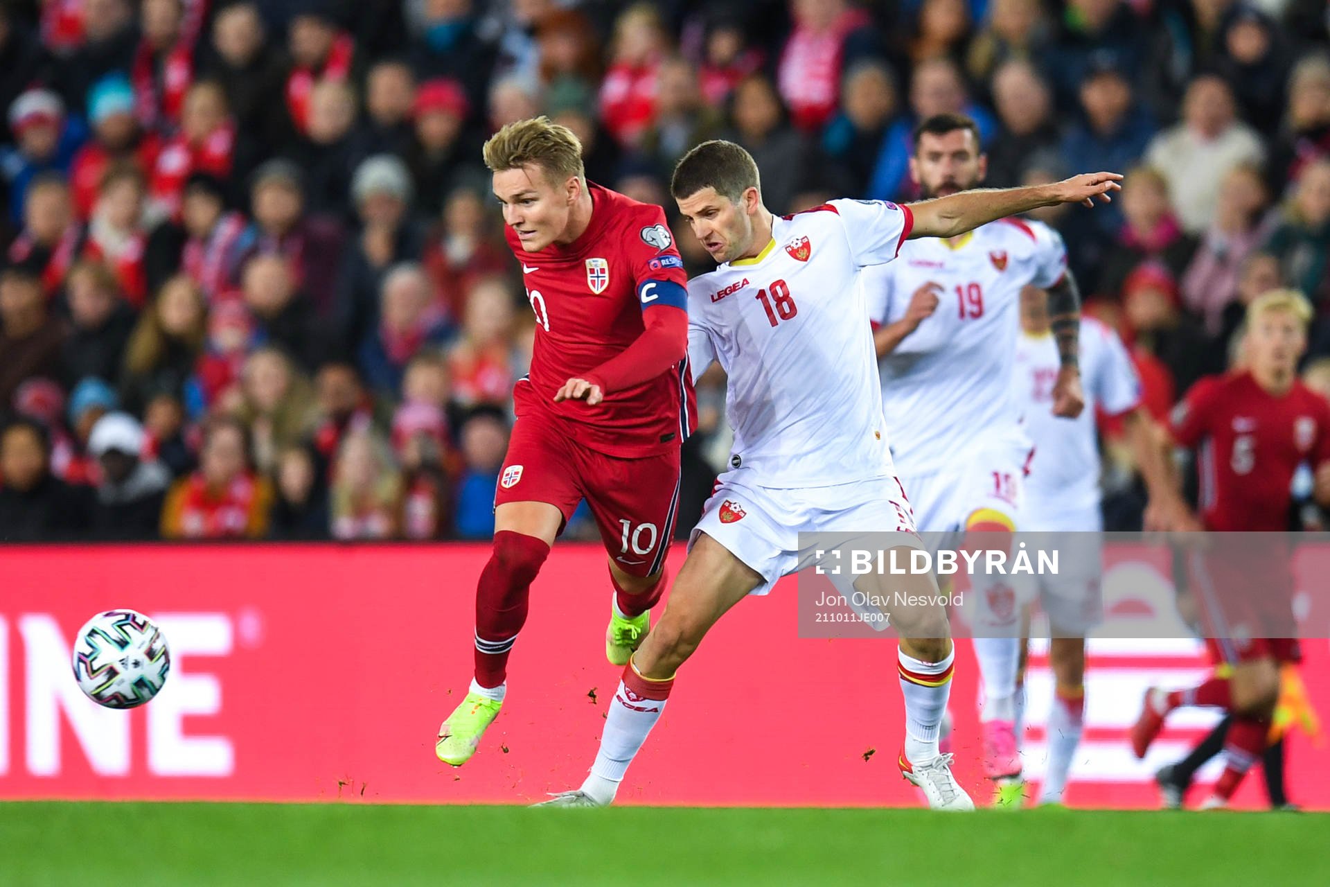 Martin Ødegaard of Norway and Nebojsa Kosovic of Montenegro