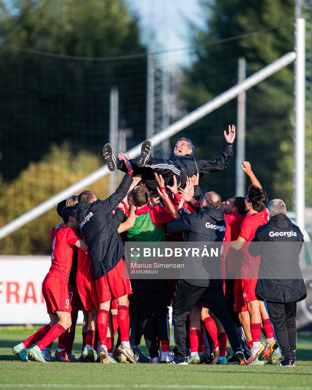 Players of Georgia celebrates with Vasil Maisuradze, head coach of Georgia, after the UEFA Euro Under-18 Qualifier football match between Norway and Georgia on October 12, 2021 in Larvik.