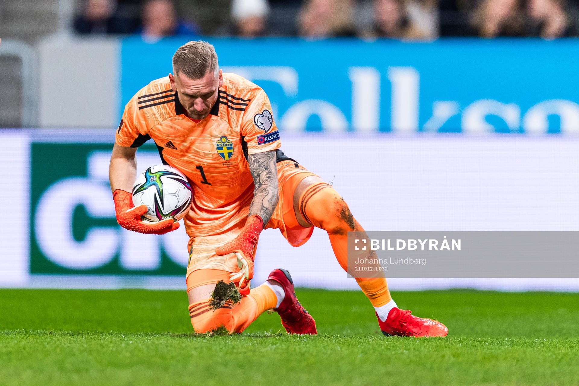 Goalkeeper Robin Olsen of Sweden throws a patch of grass