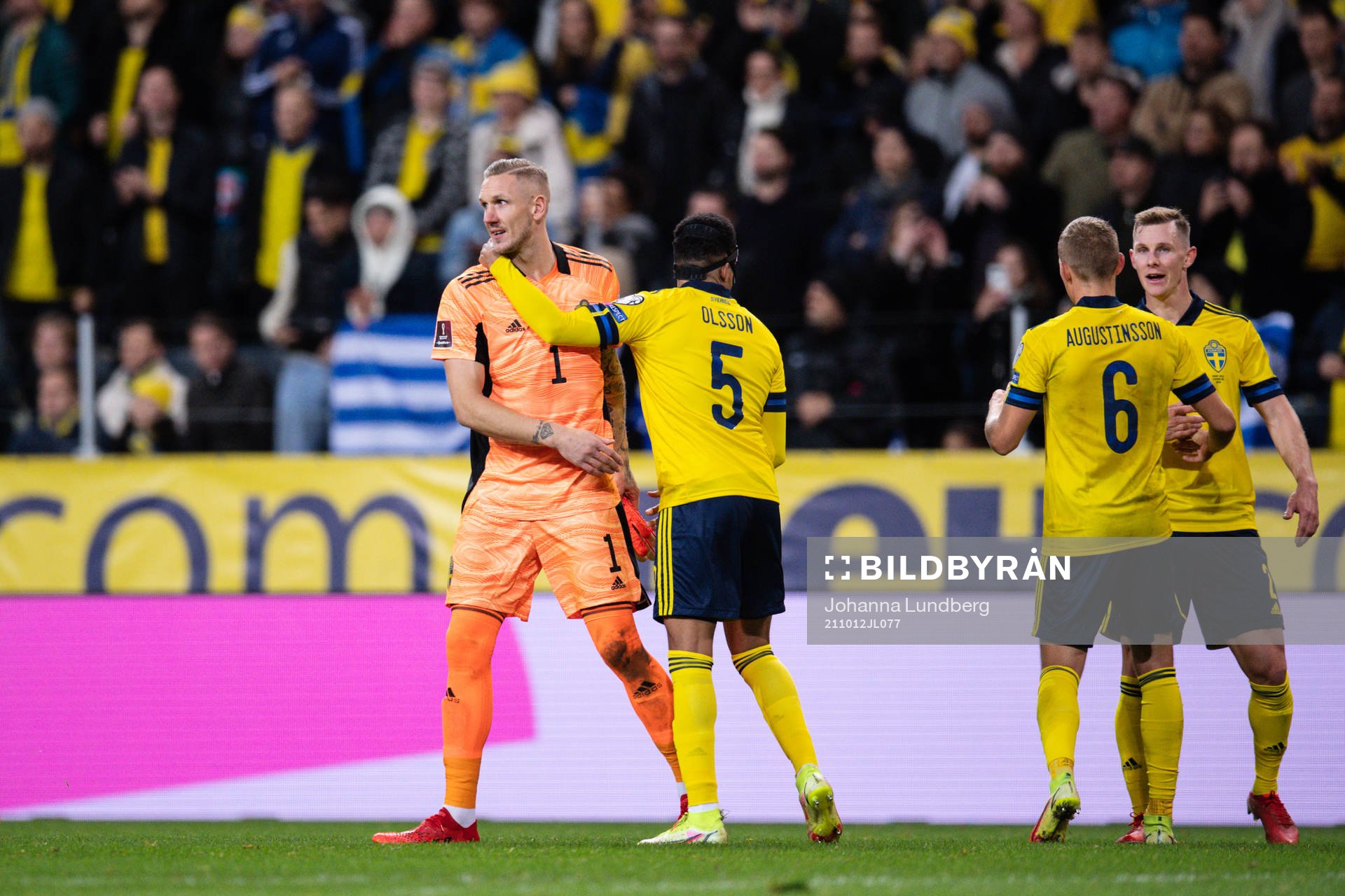 goalkeeper Robin Olsen and Martin Olsson of Sweden celebrate
