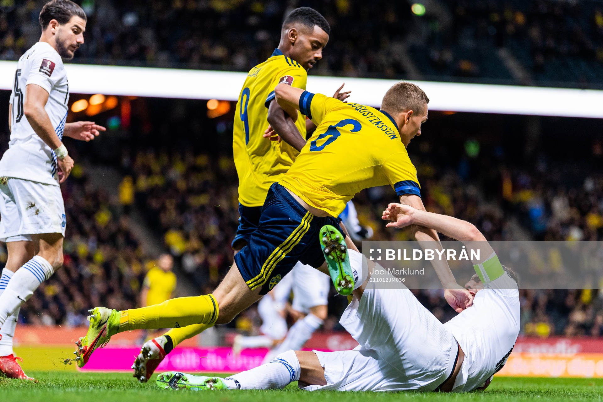 Alexander Isak and Ludwig Augustinsson of Sweden compete