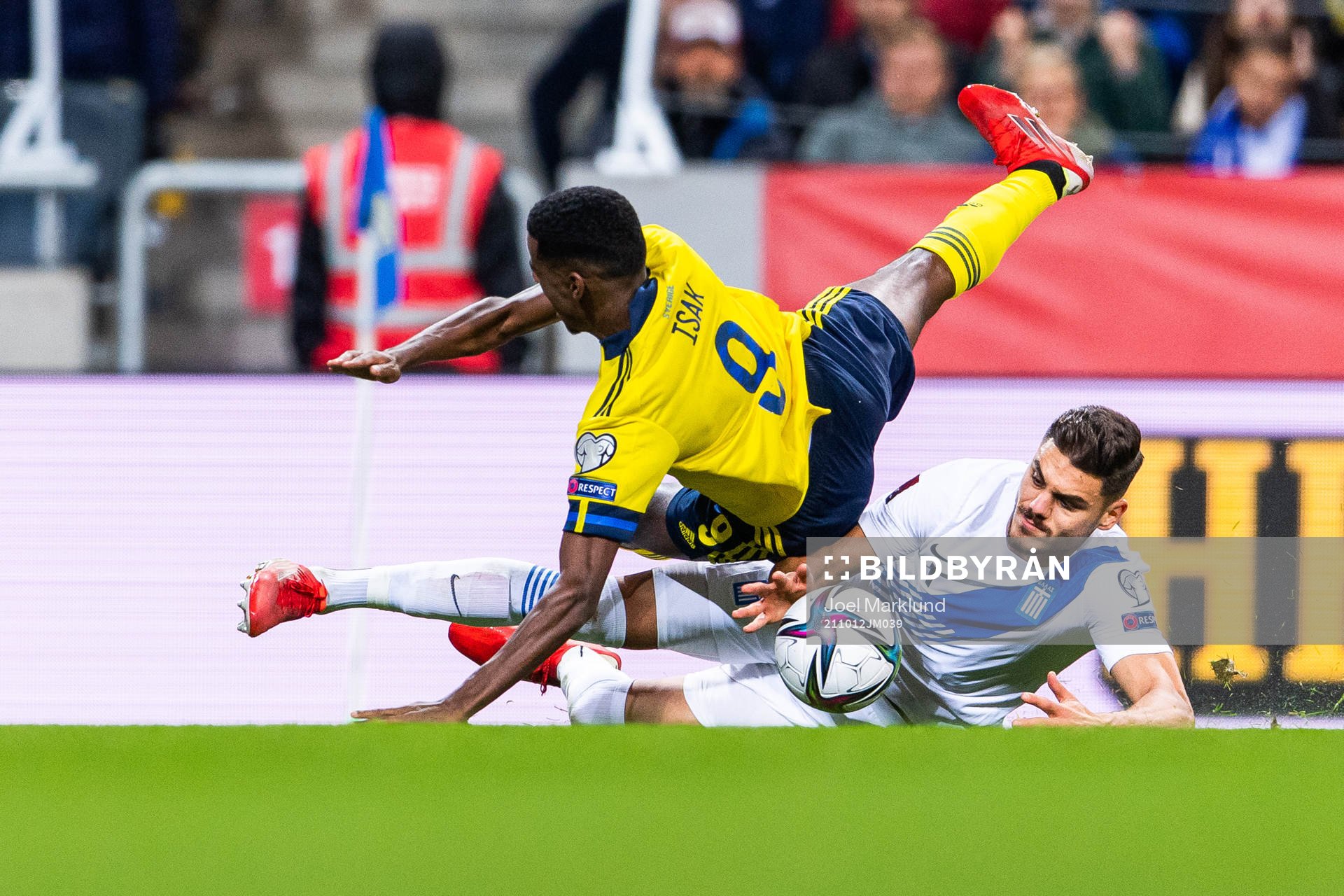 Alexander Isak of Sweden is tackled byKonstantinos