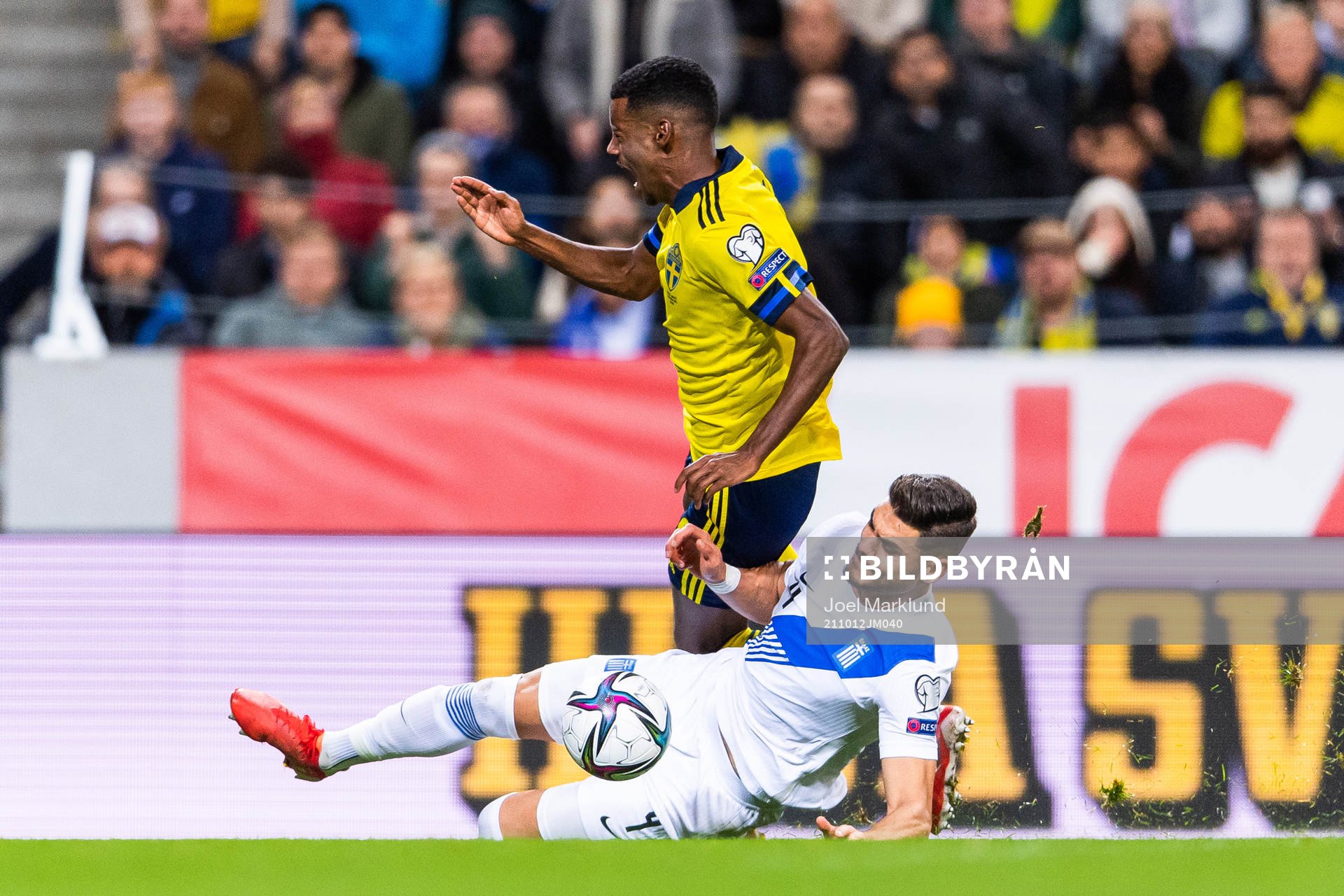 Alexander Isak of Sweden is tackled byKonstantinos