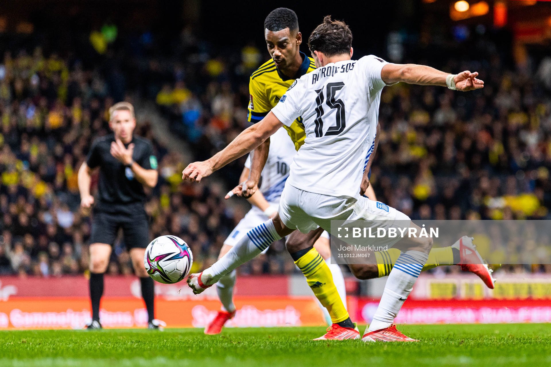 Alexander Isak of Sweden drives the ball past Thanasis