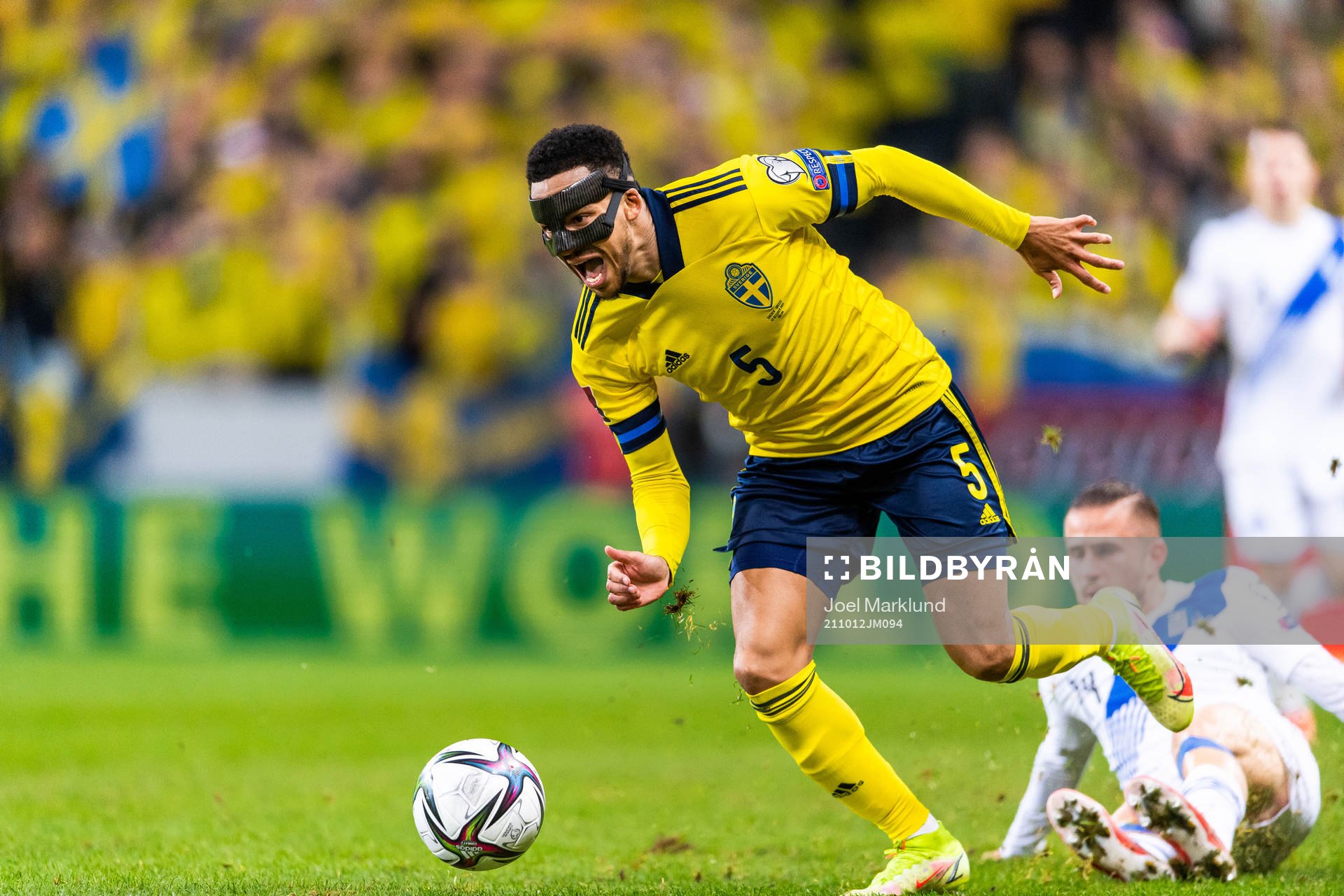 Martin Olsson of Sweden drives the ball past Dimitris