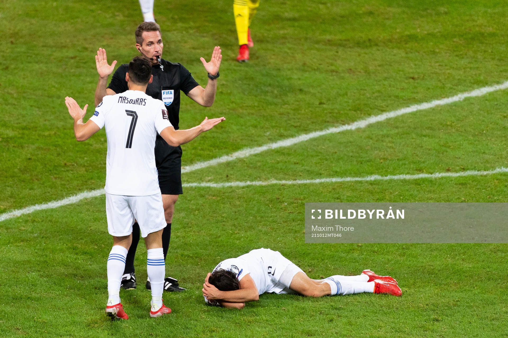 Giorgos Masouras of Greece and referee Tobias Stieler