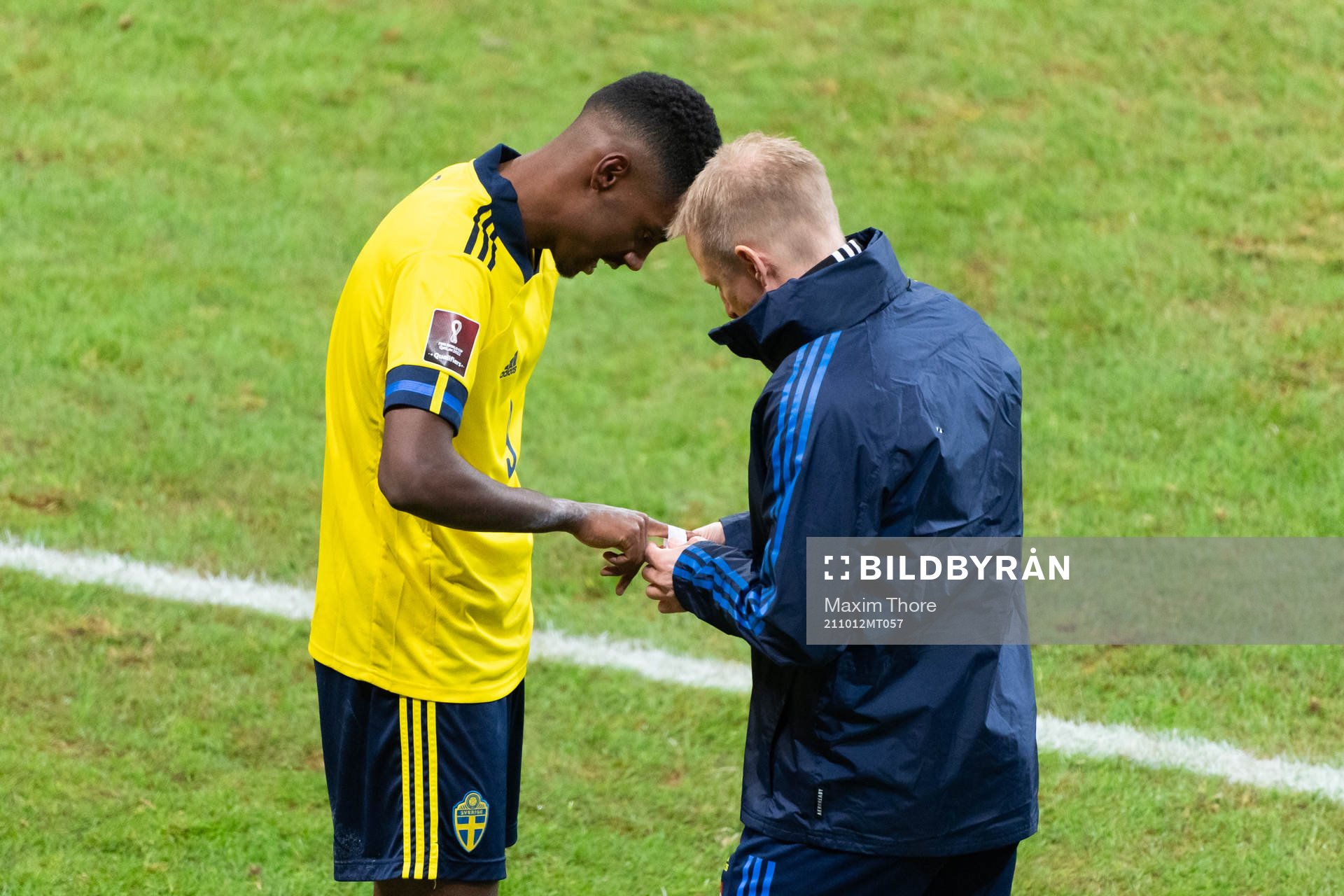 Alexander Isak of Sweden receives medical treatment to his
