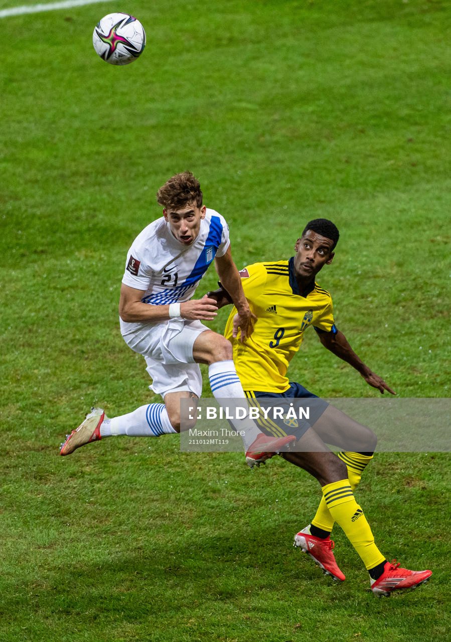 Kostas Tsimikas of Greece and Alexander Isak of Sweden