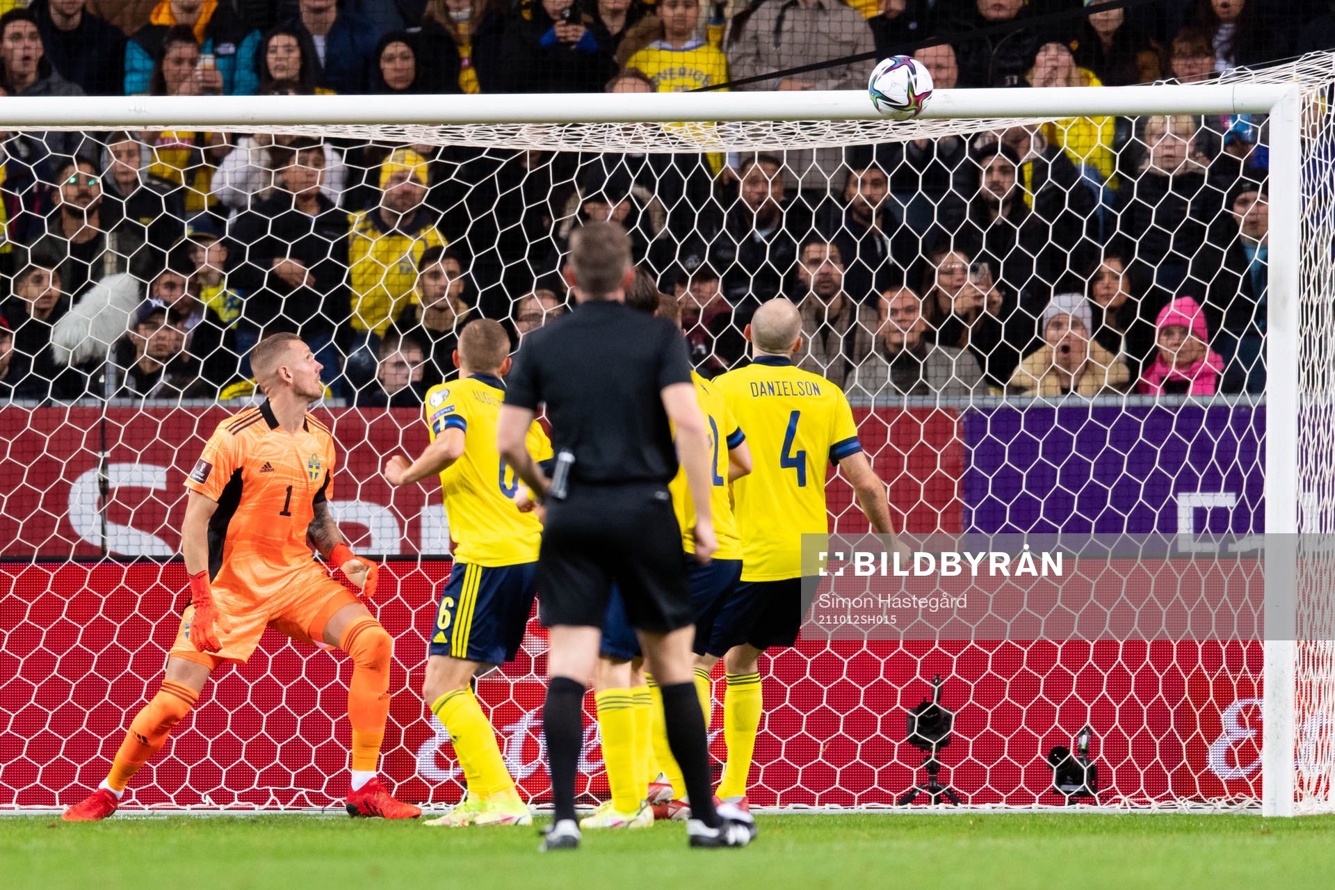 The ball hits the crossbar behind goalkeeper Robin Olsen of
