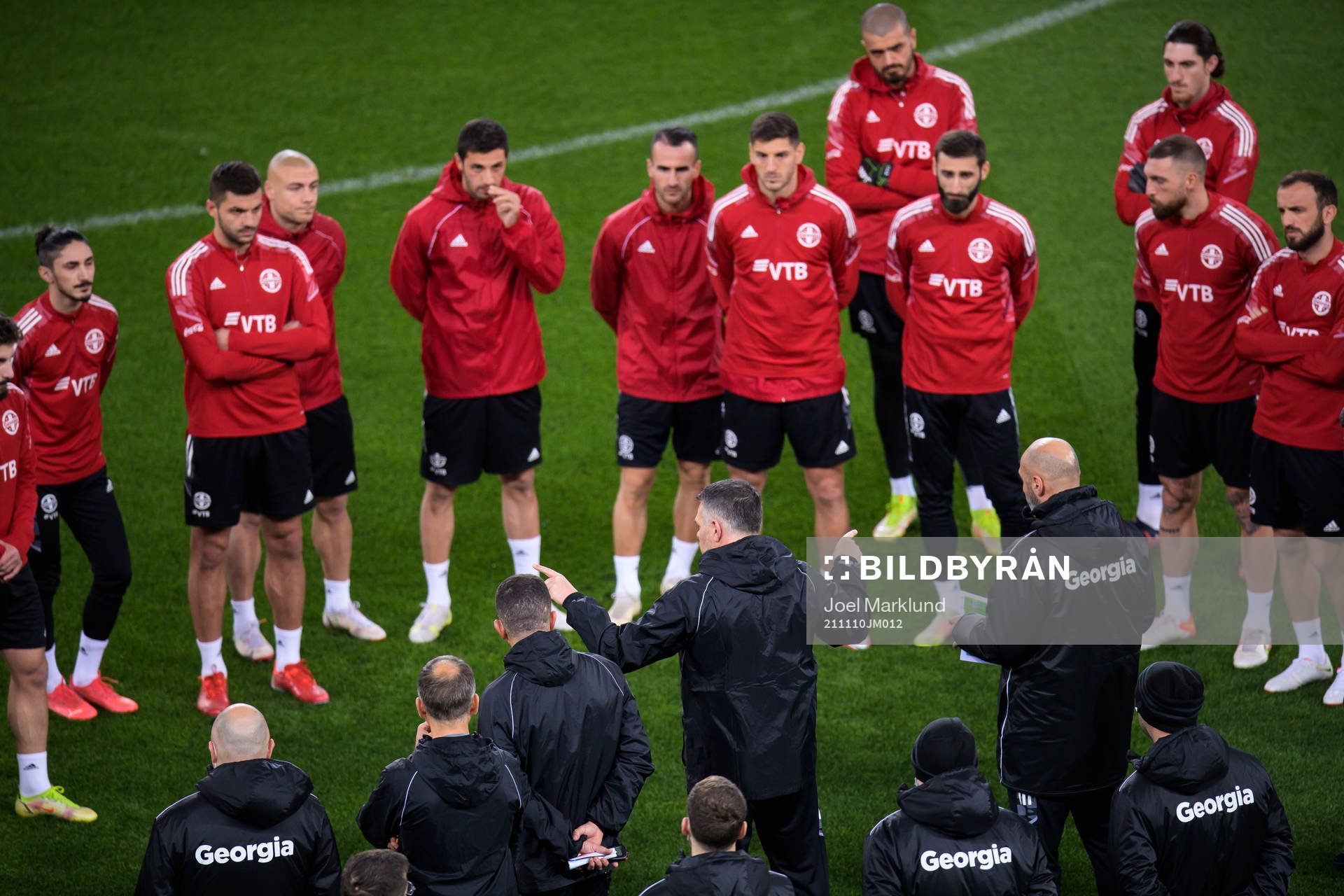 Players listen to head coach Willy Sagnol of the Georgian