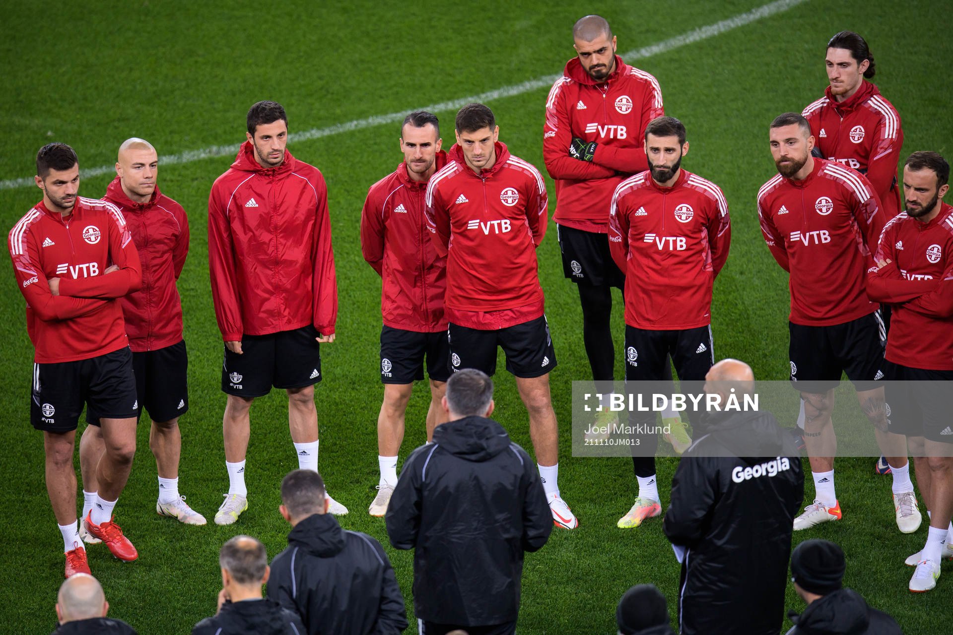 Players listen to head coach Willy Sagnol of the Georgian